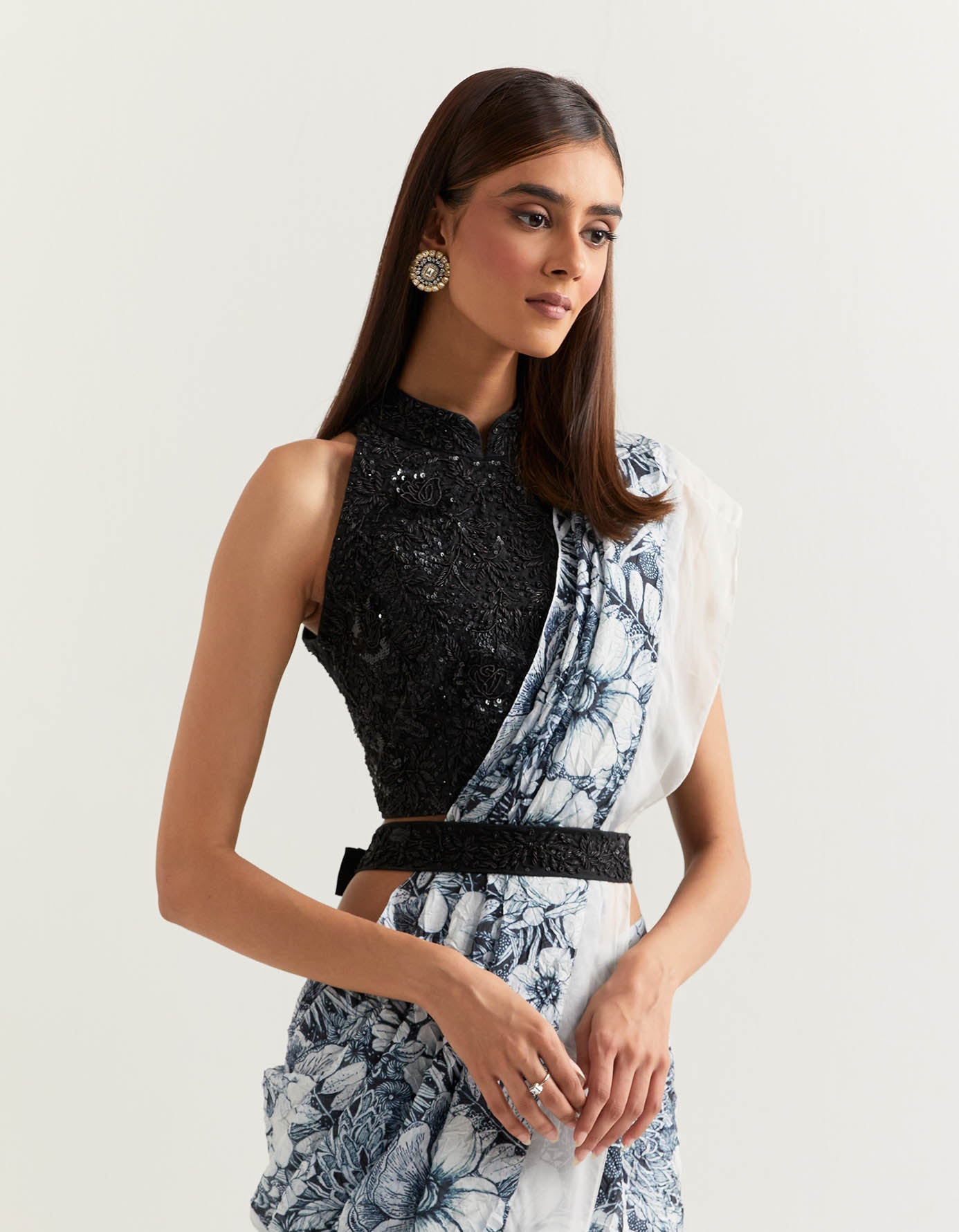 Stretch lycra hand embellished halter blouse paired with crush silk printed pre stitched saree and belt