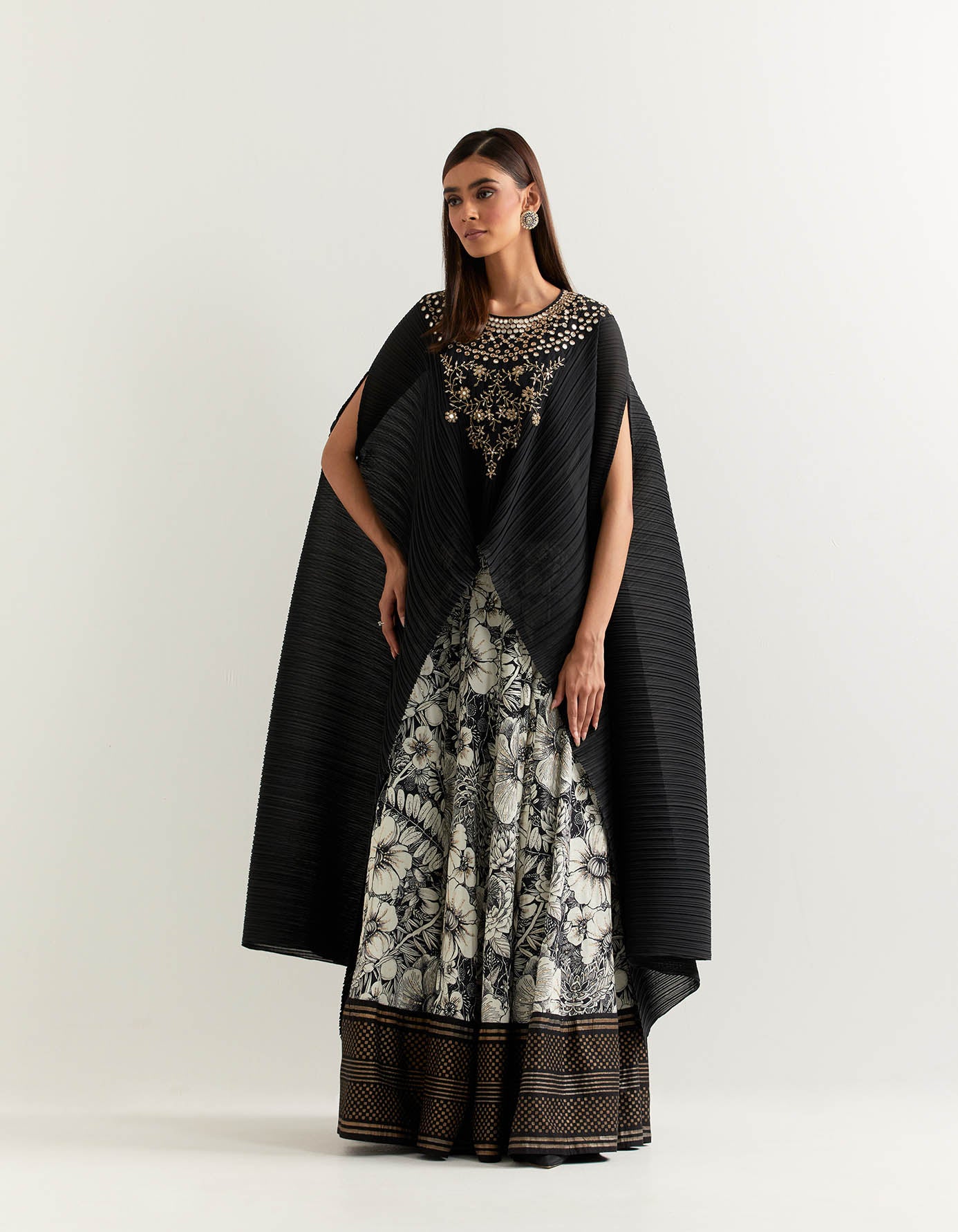 Crinkle georgette cape embellished with hand embroidered neck line paired with panelled printed skirt