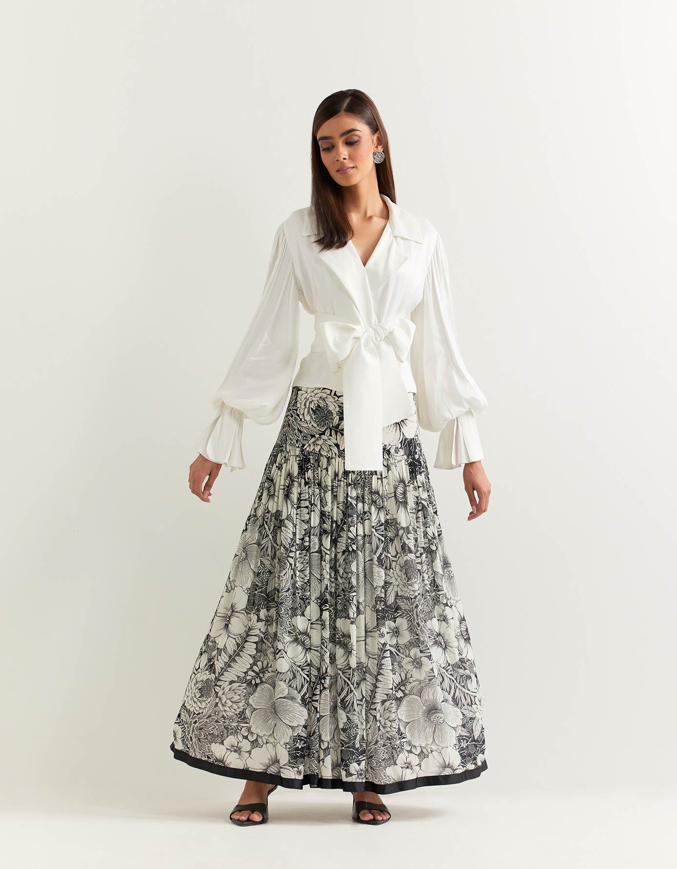 Ivory lantern sleeve double breasted top paired with organza printed skirt with stretch waist and ruffle detail