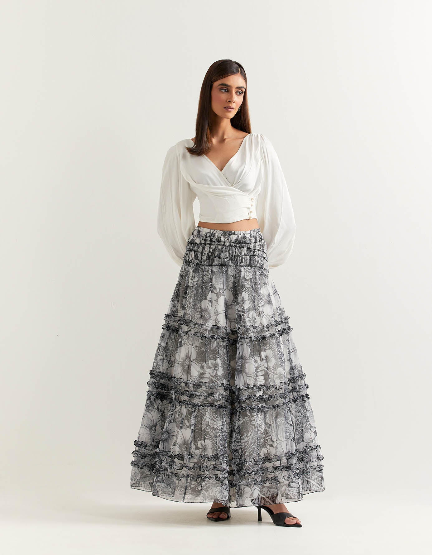 Ivory lantern sleeve double breasted top paired with organza printed skirt with stretch waist and ruffle detail