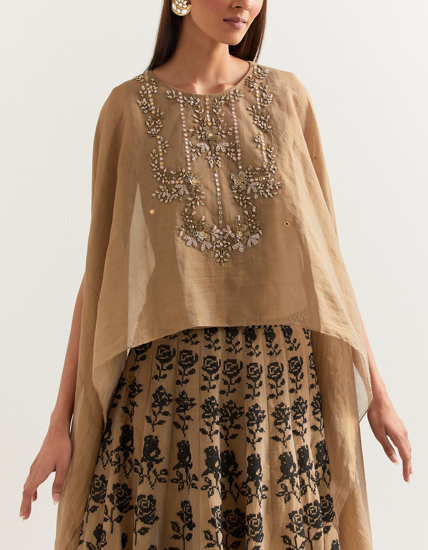 Chanderi tissue hand embellished dupatta cape paired with cross stitch rose embroidered skirt