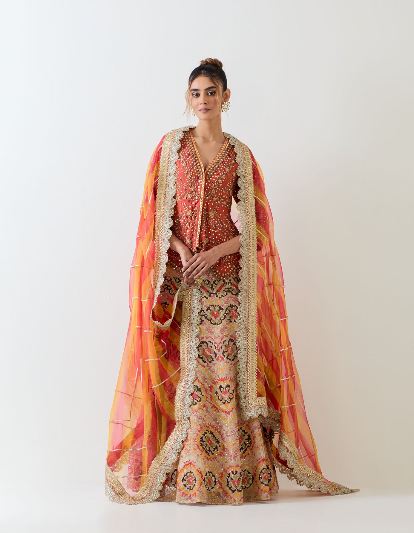 Tissue chandero hand embellsihed peplum top paired with cross stitch embroidered organza skirt and tie dye organza dupatta