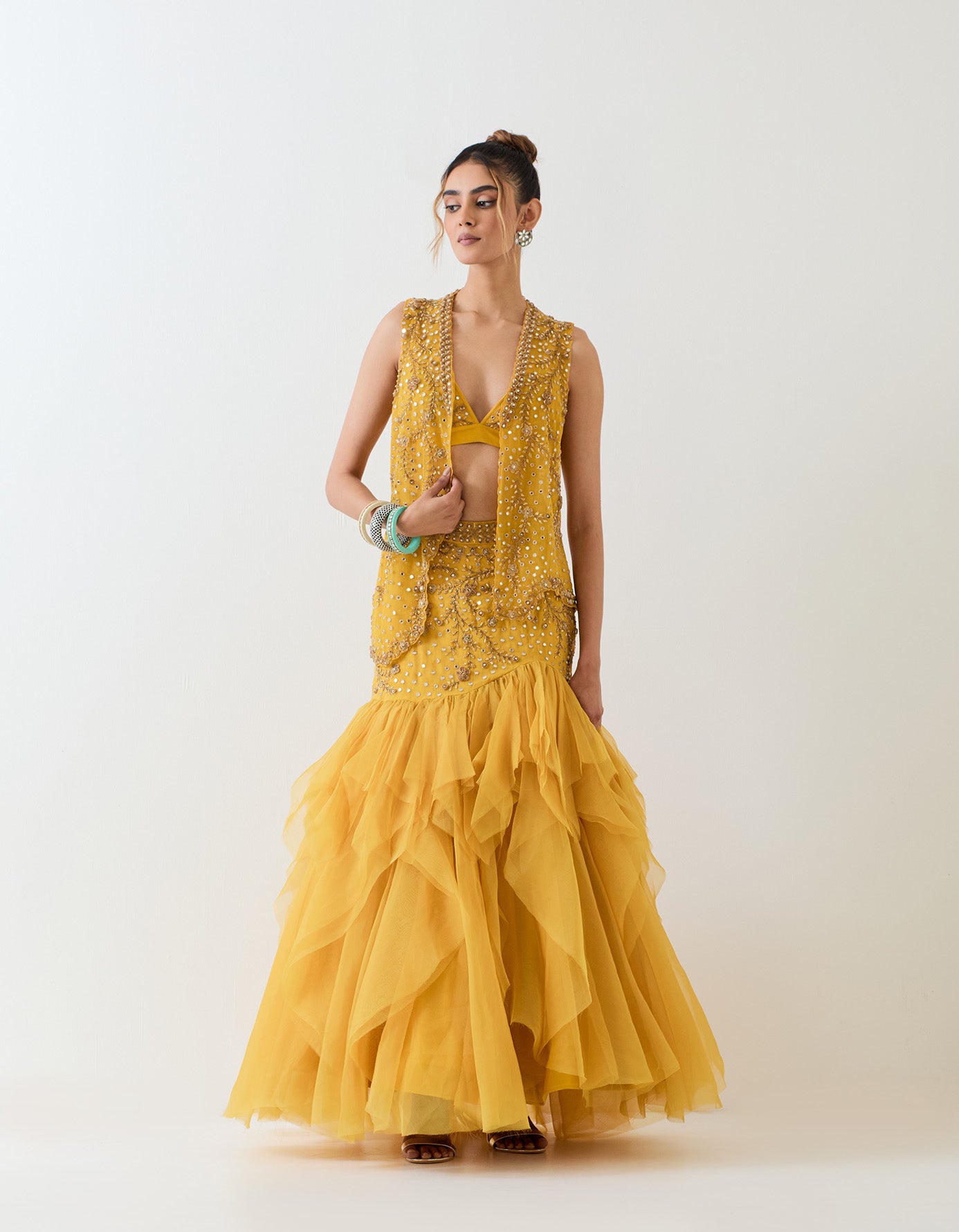 Mustard yellow organza skirt with hand embroidered basque waist paired with hand embellished bralet and mesh jacket
