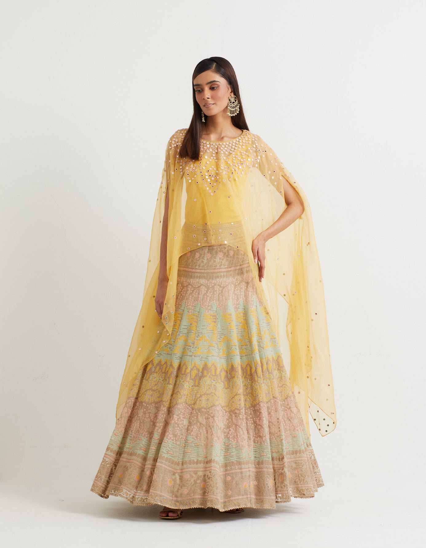 Lemon cross stitch embroidered skirt in landscape motif paired with organza dupatta cape in mirror embroidery
