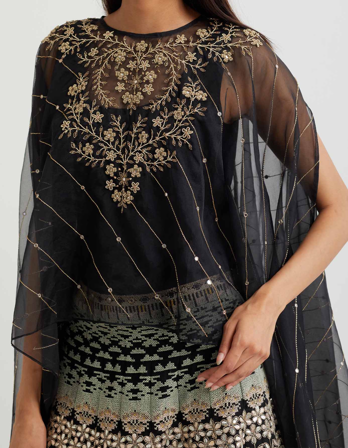Black cross stitch embroidered skirt in landscape motif paired with organza dupatta cape in zardozi embroidery