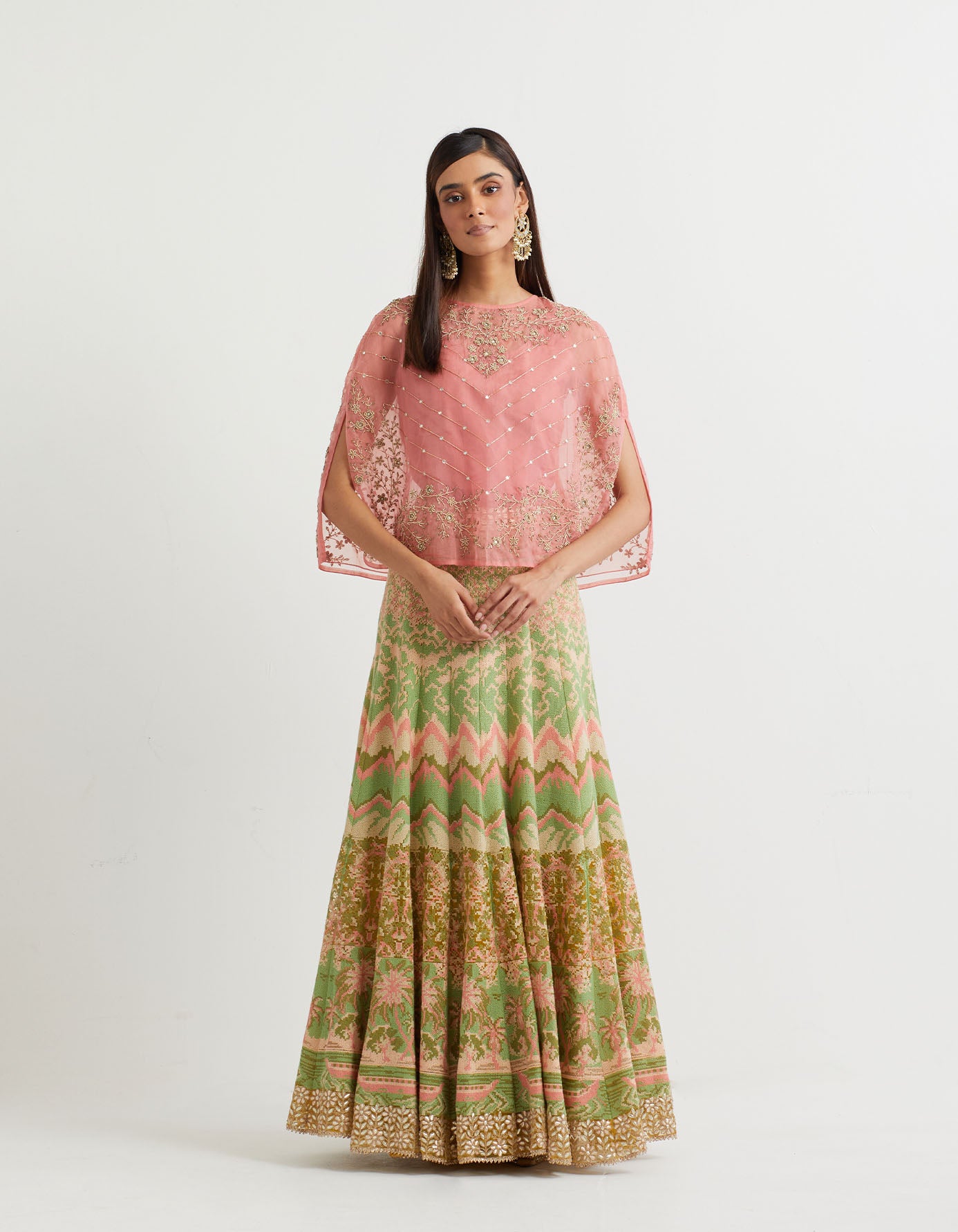 Peachy pink cross stitch embroidered skirt in landscape motif paired with organza cape in mirror zardozi embroidery