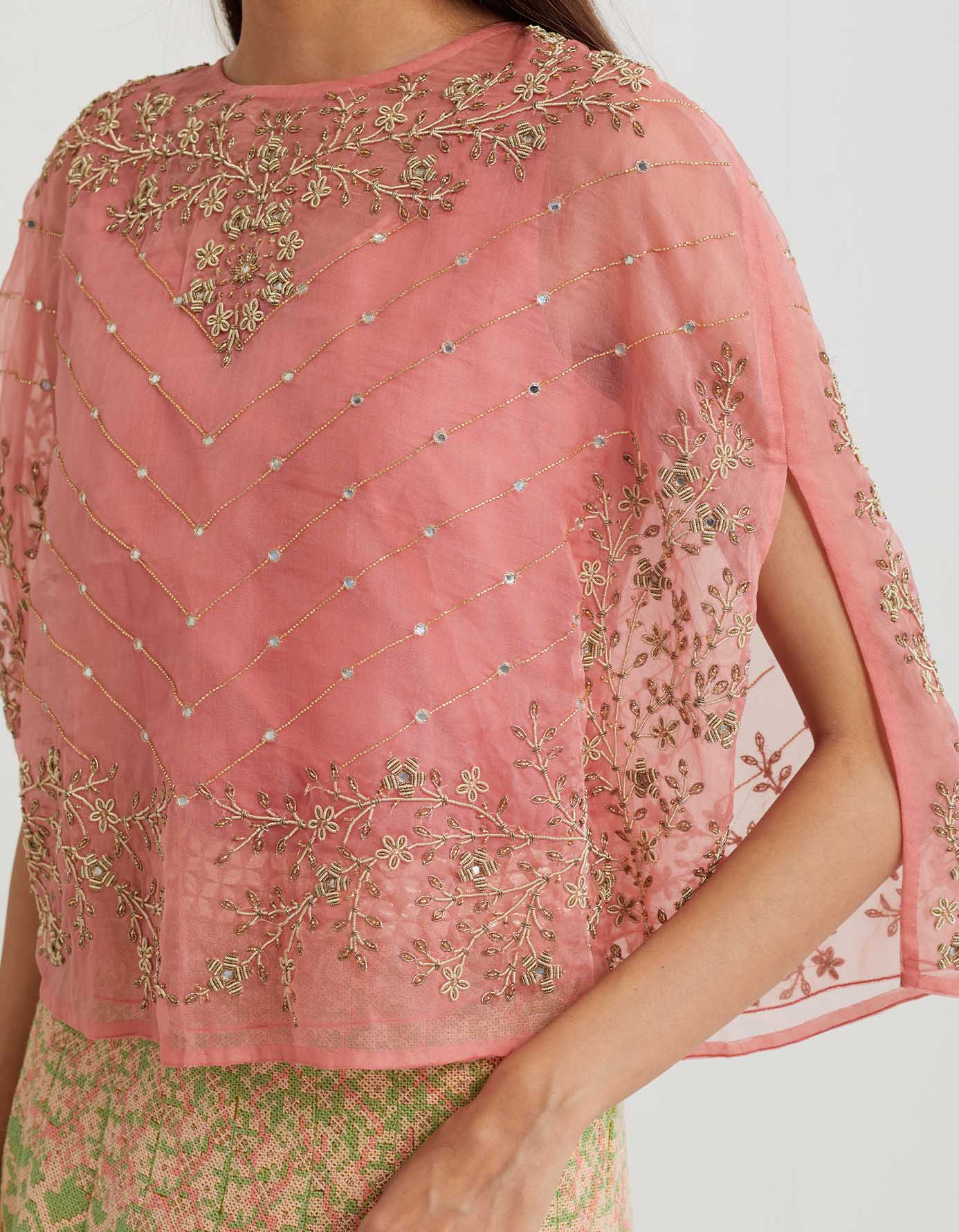 Peachy pink cross stitch embroidered skirt in landscape motif paired with organza cape in mirror zardozi embroidery