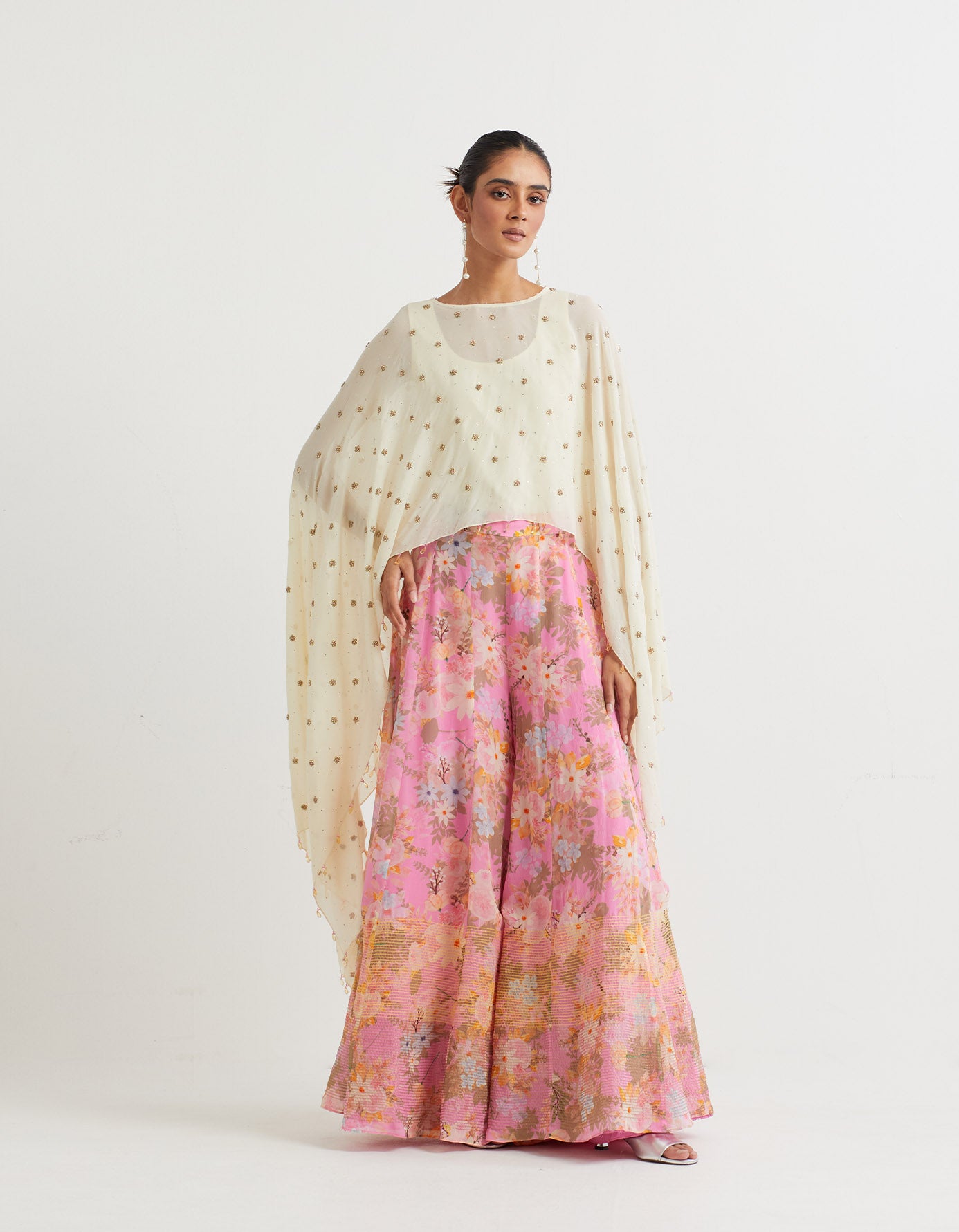 Printed panelled sharar with textured bottom paired with all over hand embroidered cape