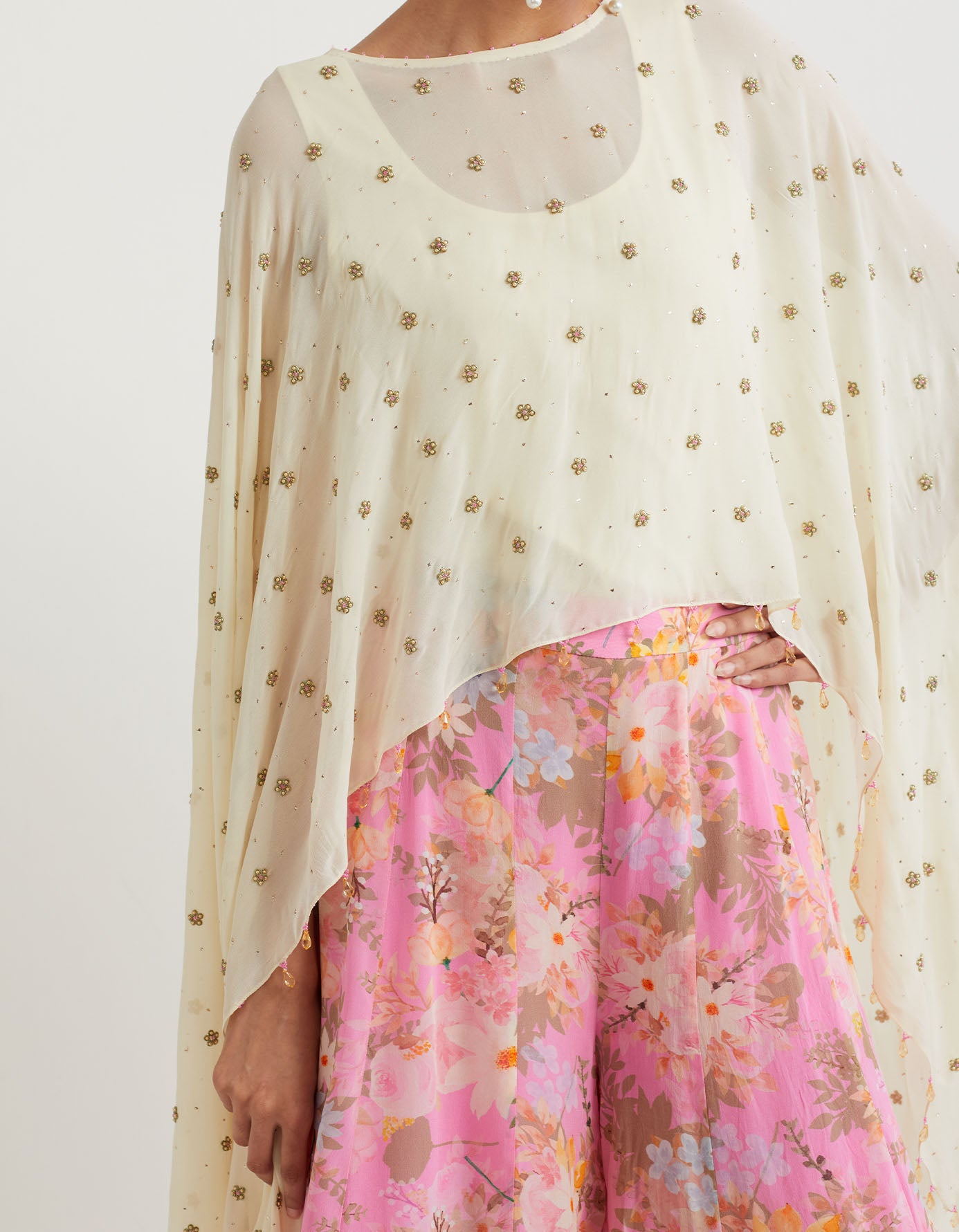 Printed panelled sharar with textured bottom paired with all over hand embroidered cape