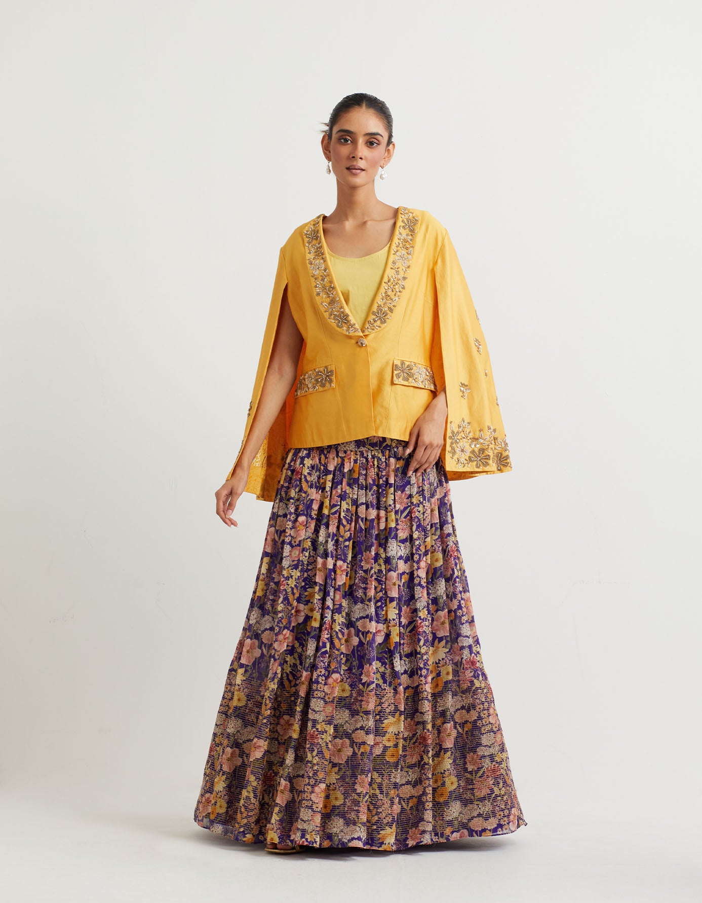 Printed gathered lehnga with textured bottom paired with cape sleeve embroidered jacket