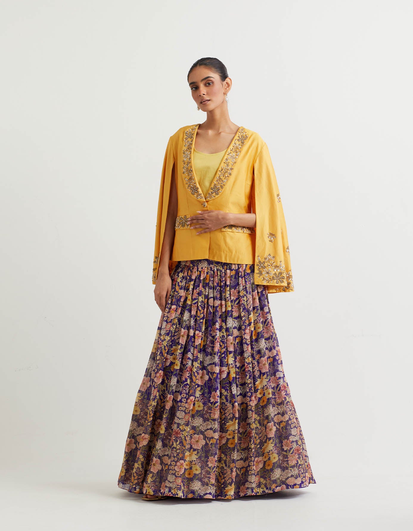Printed gathered lehnga with textured bottom paired with cape sleeve embroidered jacket
