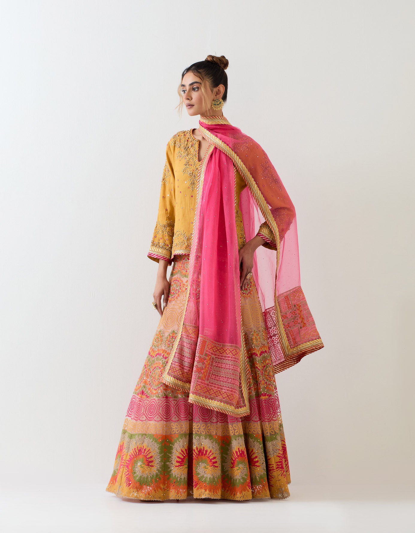 Tissue chanderi mustard hand embellished kurti top paired with cross stitch embroidered skirt and organza hand embellished dupatta