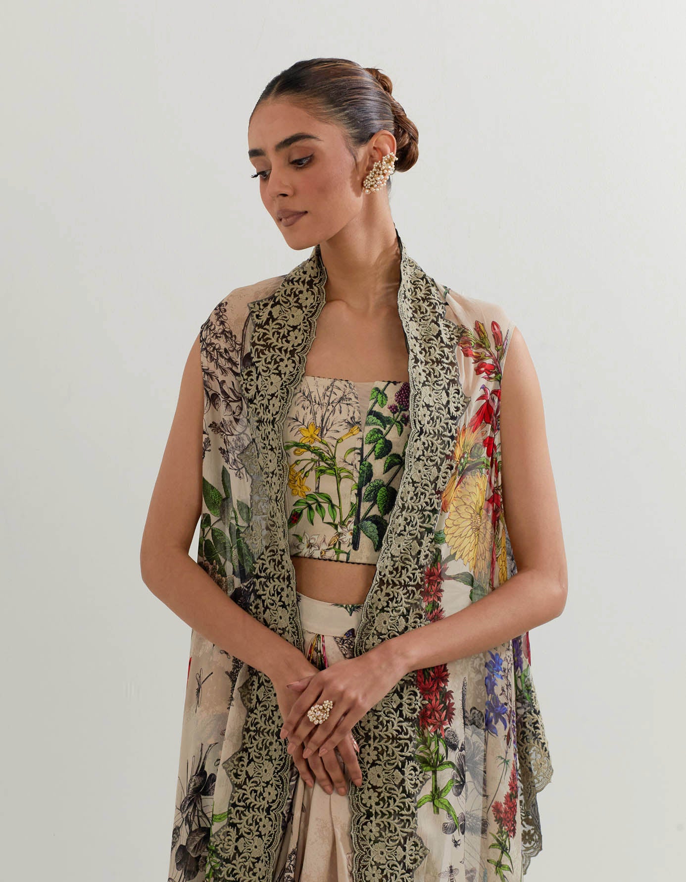 Botanical printed drape skirt paired with stretch bustier and printed cape