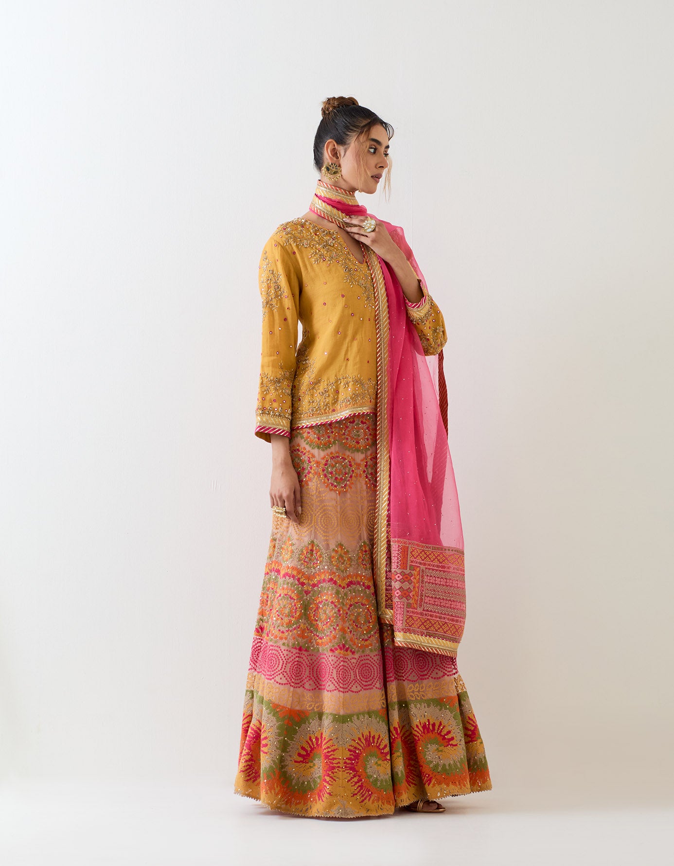 Tissue chanderi mustard hand embellished kurti top paired with cross stitch embroidered skirt and organza hand embellished dupatta