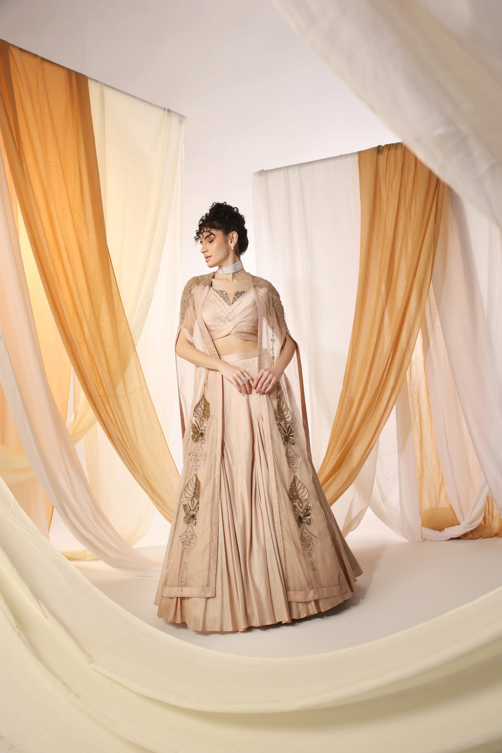 Lehenga Set Combined With A Pleated Blouse and Embellished Organza Cape
