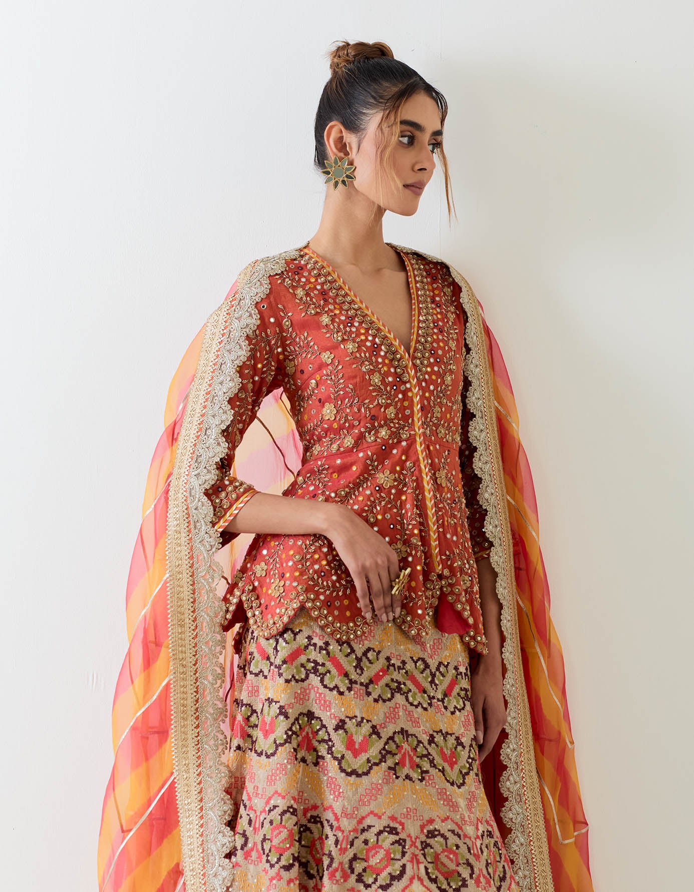 Tissue chandero hand embellsihed peplum top paired with cross stitch embroidered organza skirt and tie dye organza dupatta