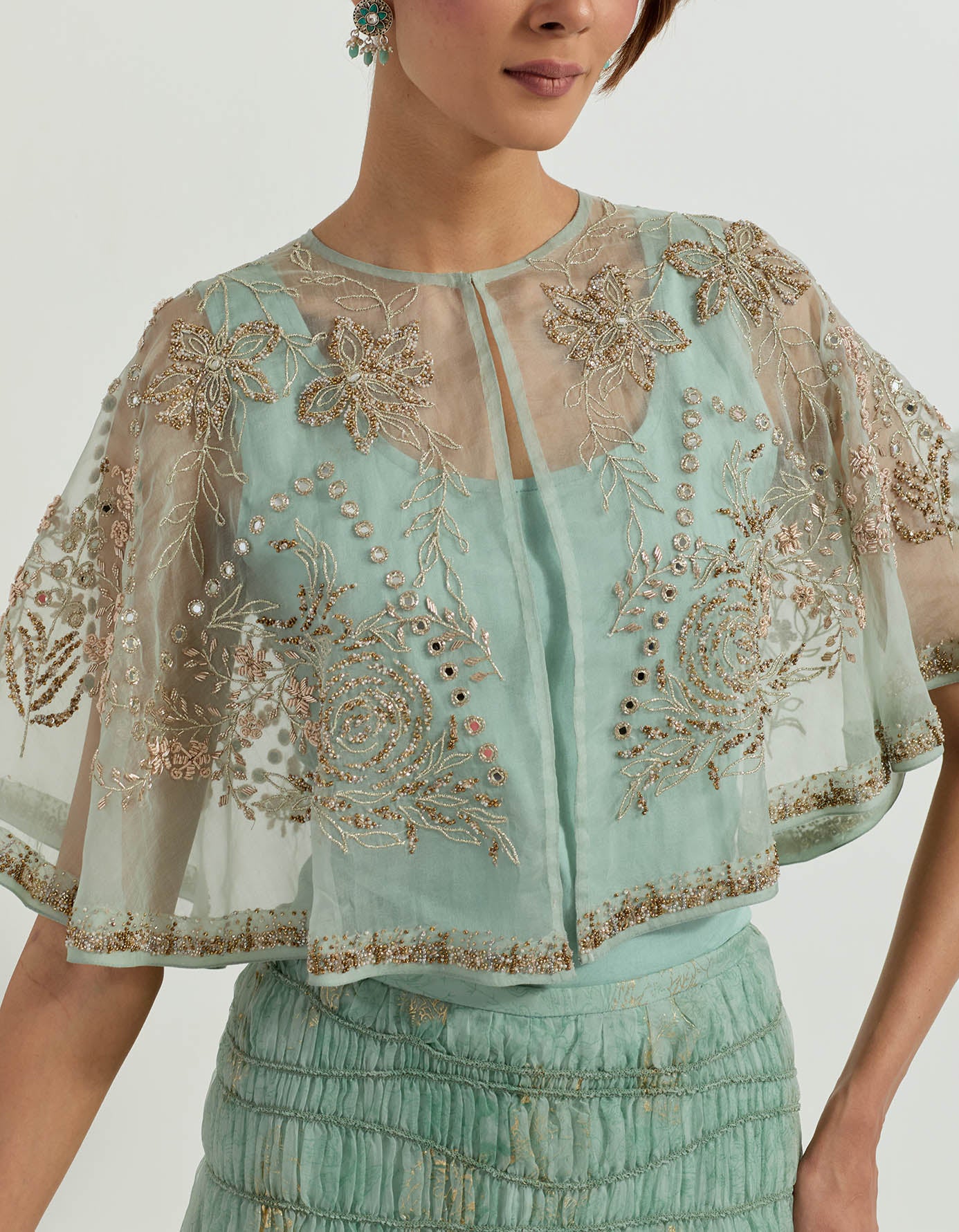 Hand embellished organza circular cape paired with tiered organza foil printed skirt with ruffle detail