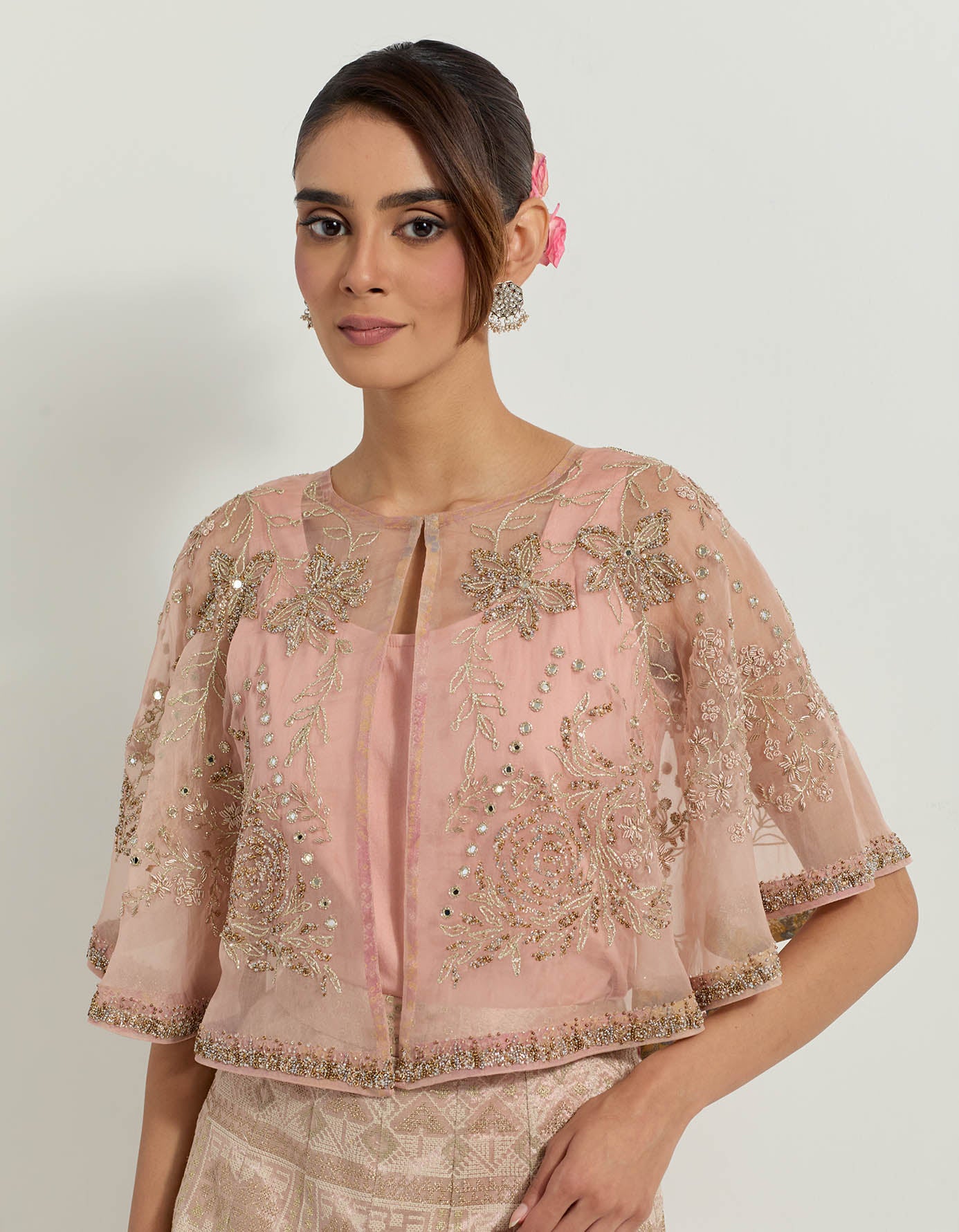 Hand embellished circular organza cape paired with blush pink tissue skirt in bandhini motifs