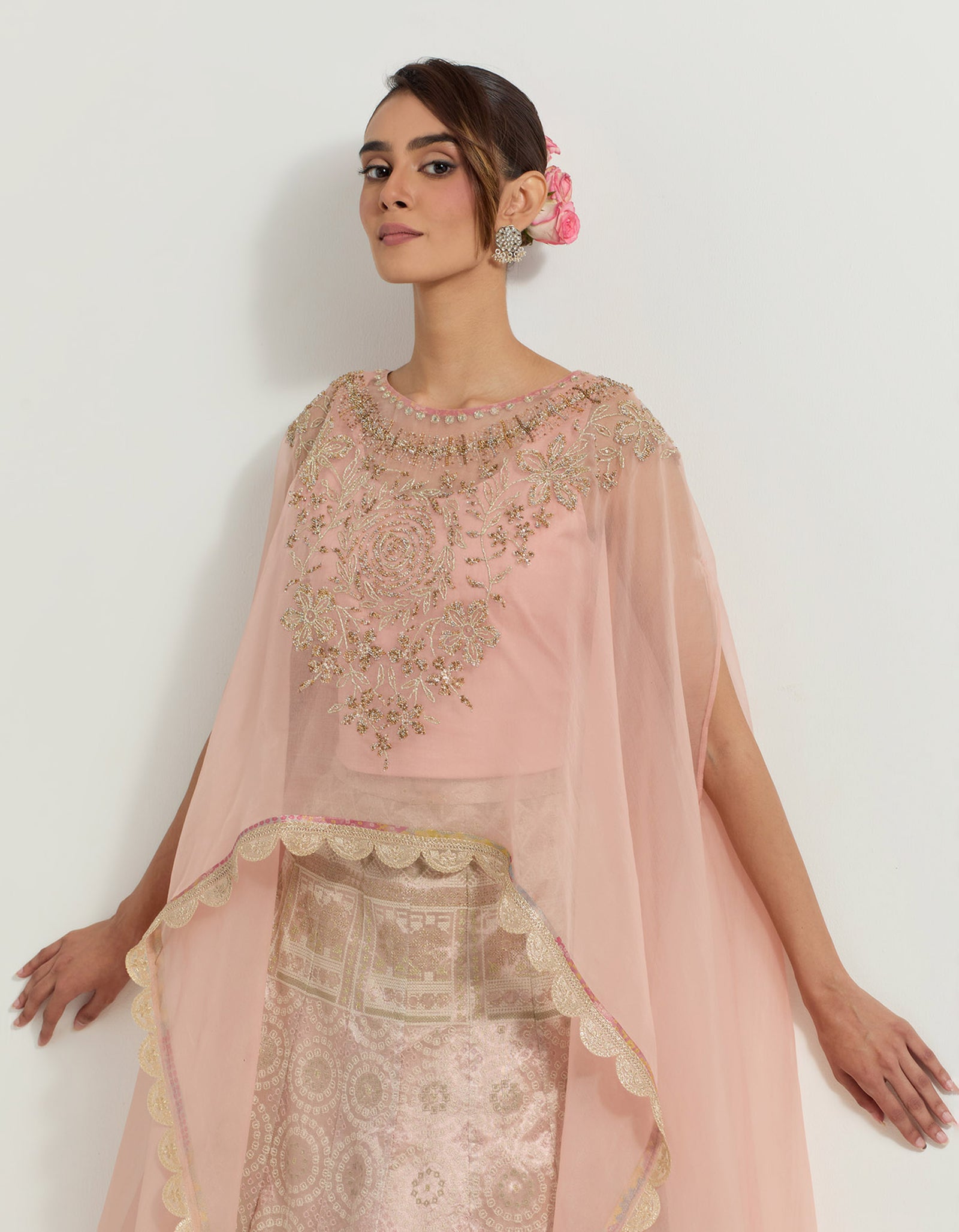 Hand embellished dupatta cape paired with blush pink tissue  skirt in bandhini motifs
