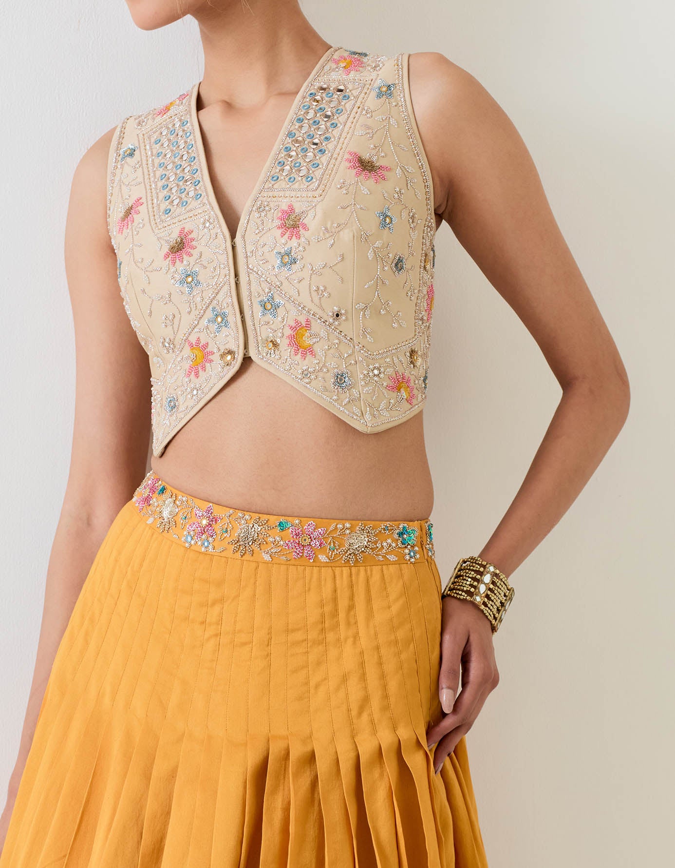 Chanderi silk hand embellished waist coat paired with circular cross stitch embroidery skirt