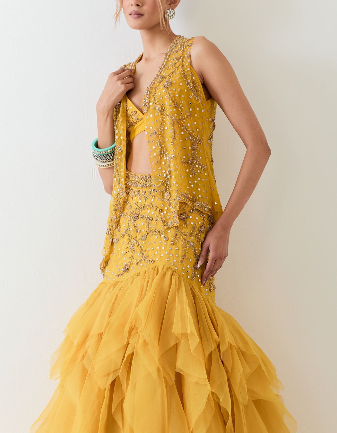 Mustard yellow organza skirt with hand embroidered basque waist paired with hand embellished bralet and mesh jacket