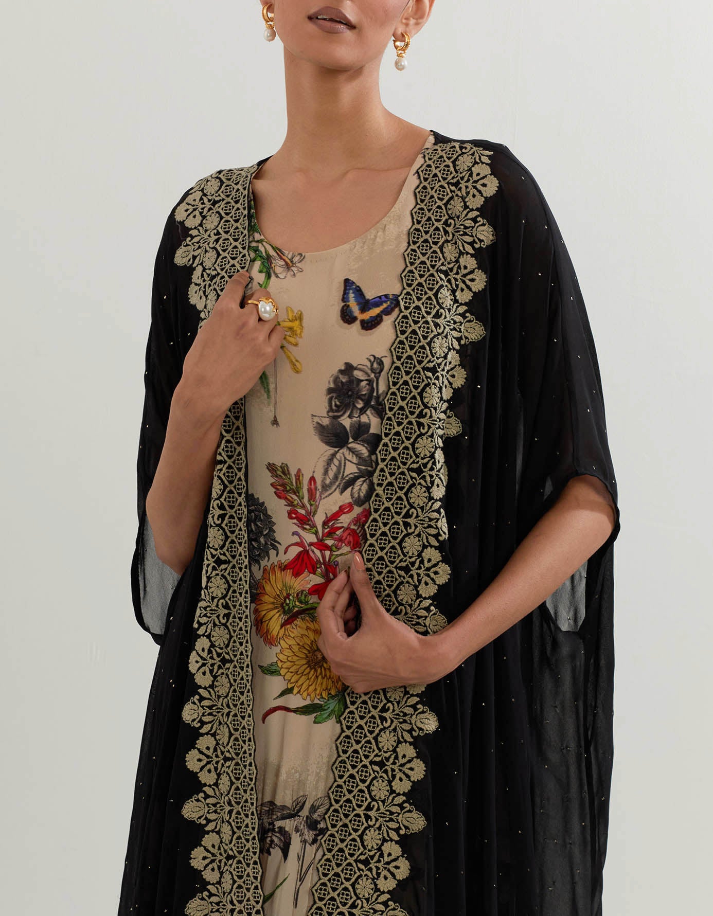 Botanical printed tiered dress paired with cape with resham embroideered border