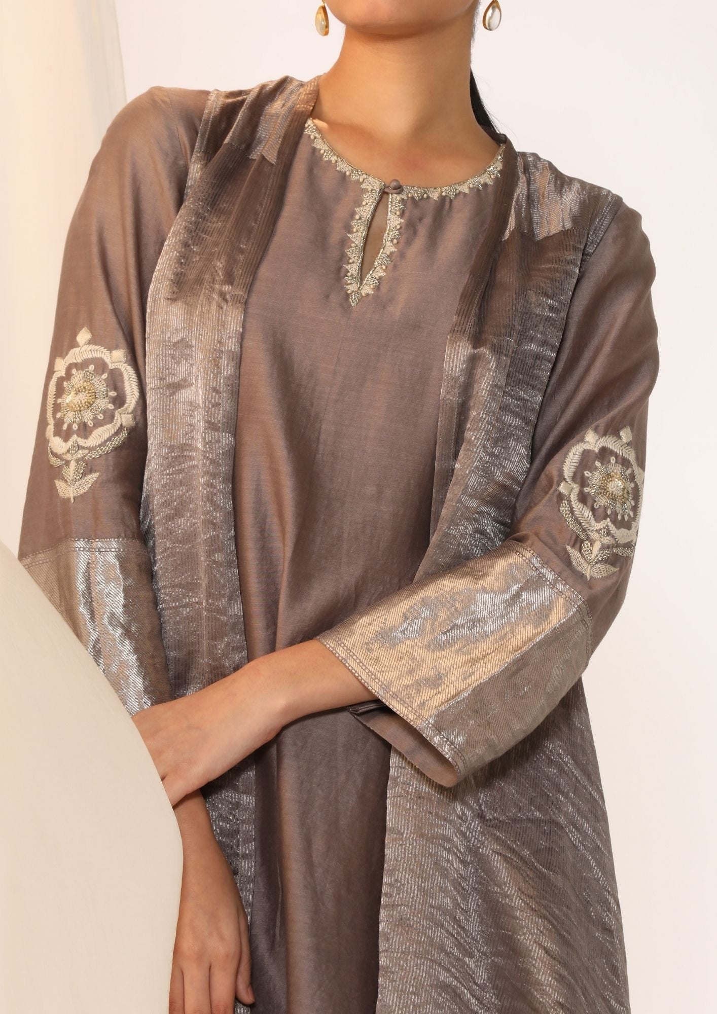 Embroidered Silk Kurta Paired With Woven Border Pants And  Tissue Assymetric Cape.