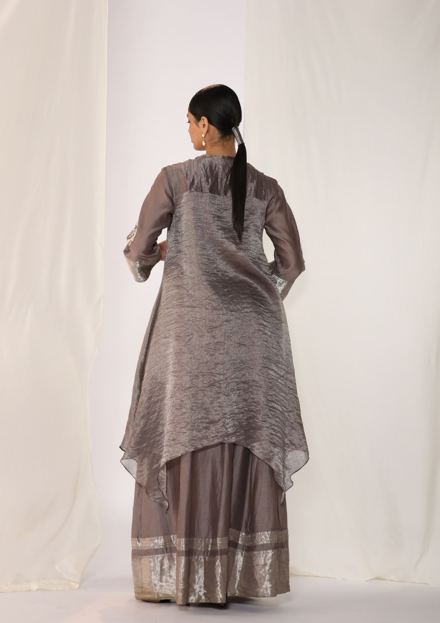 Embroidered Silk Kurta Paired With Woven Border Pants And  Tissue Assymetric Cape.