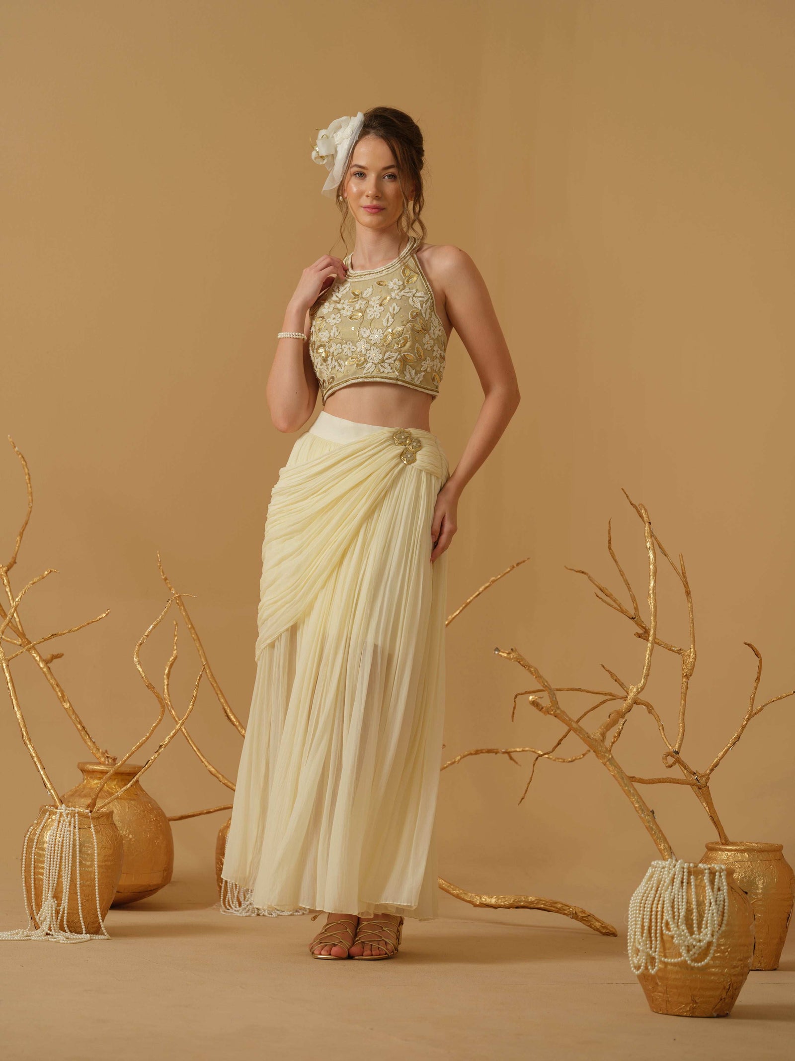 A Halter Neck Blouse Having Floral Embroidery Paired With Draped Skirt