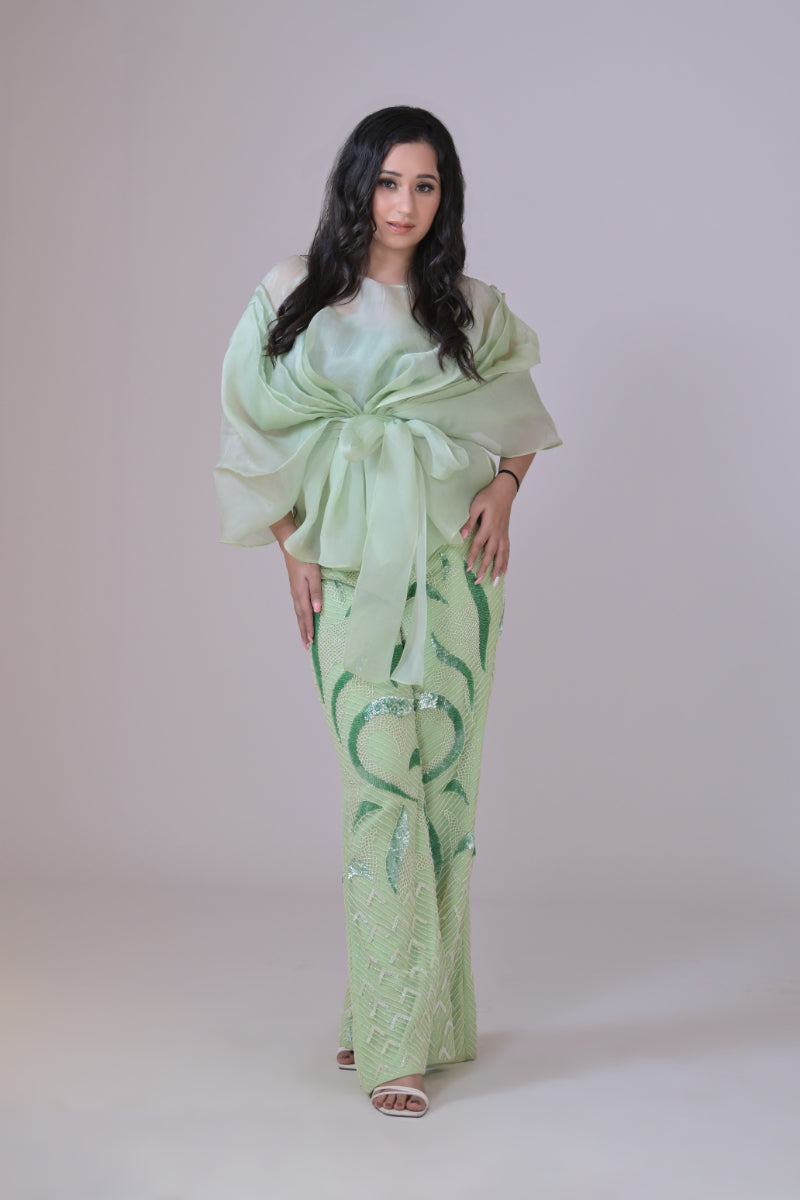 Light green hand embelished pants and an organza drape top