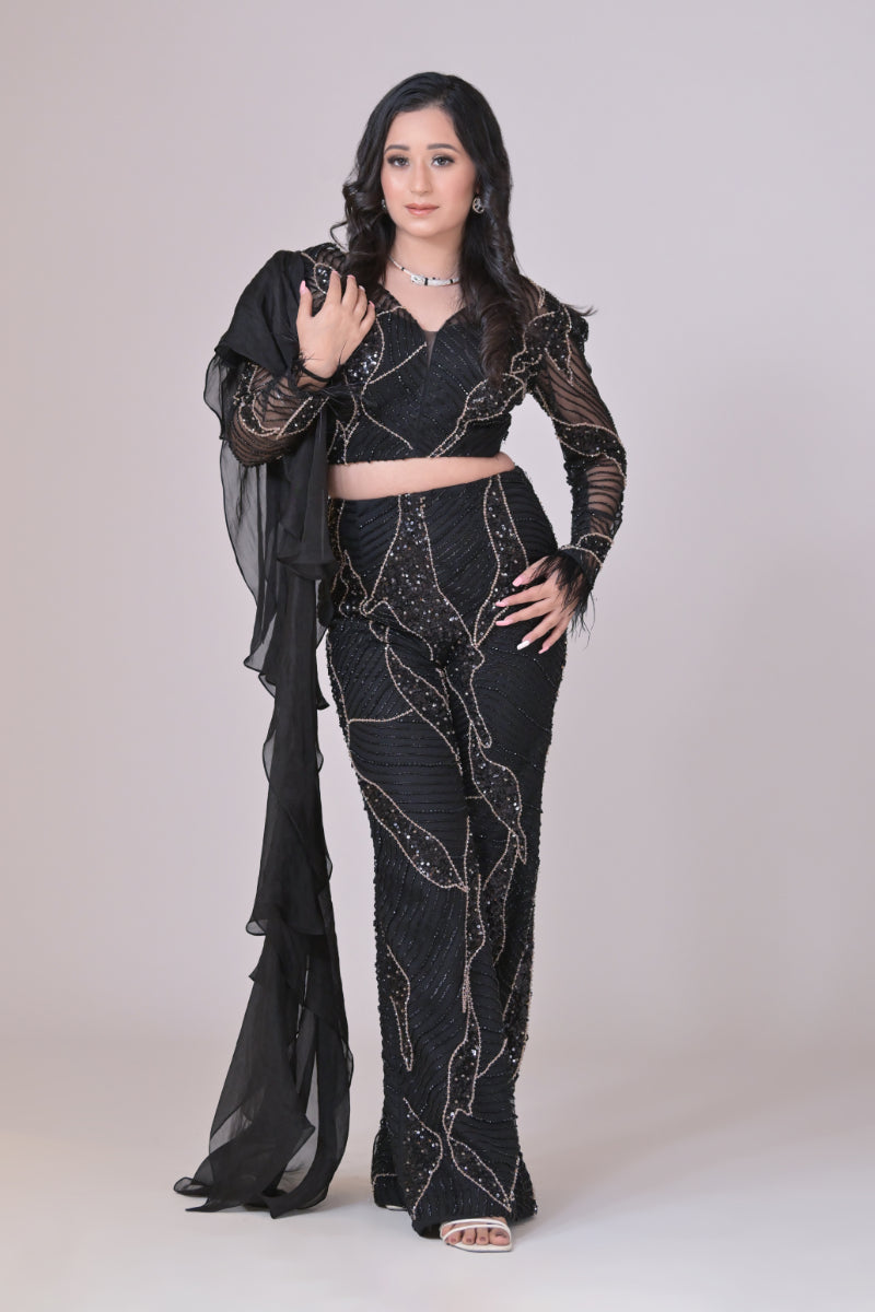 Black crop top with attached organza drape and embelished pants