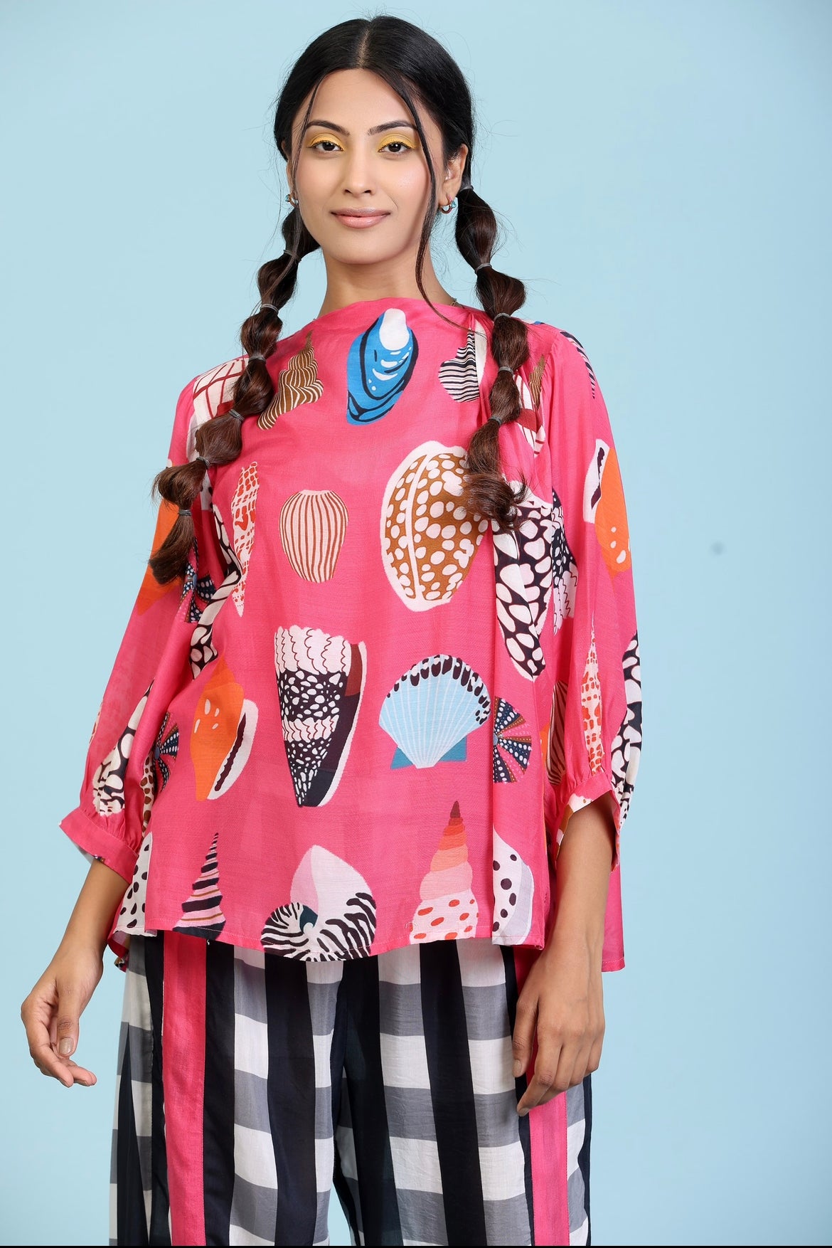 Fushcia Coral print top with black and white checks straight pant.