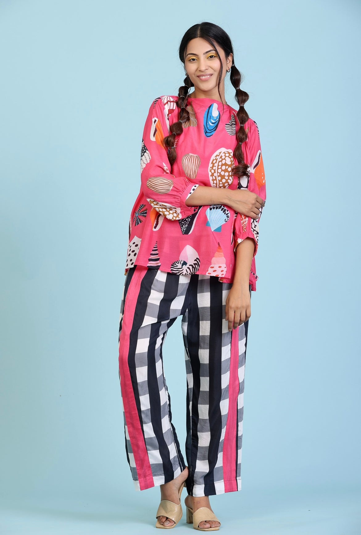 Fushcia Coral print top with black and white checks straight pant.