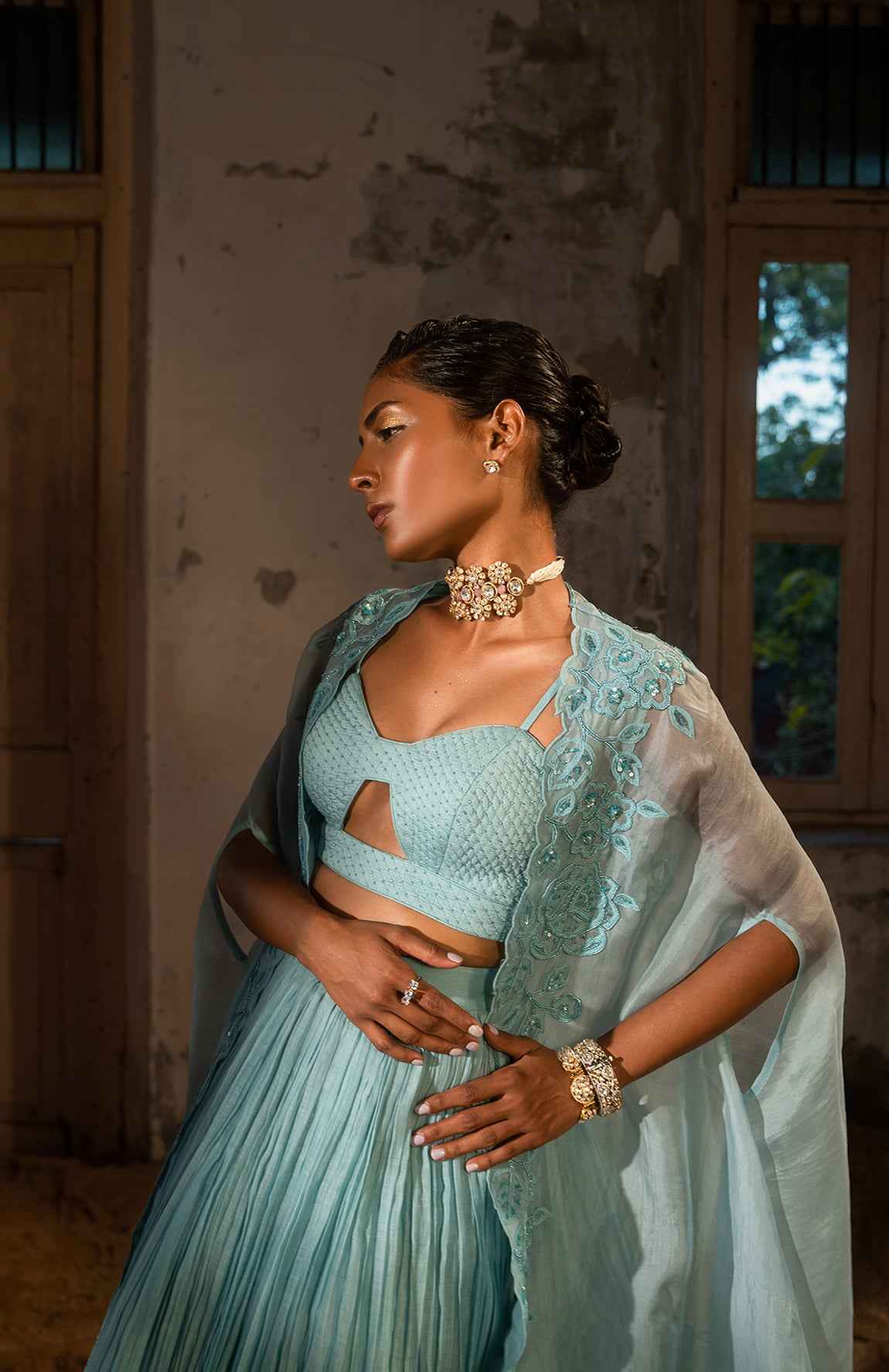 A Pwder Blue Lehenga With Maching Blouse And Cape