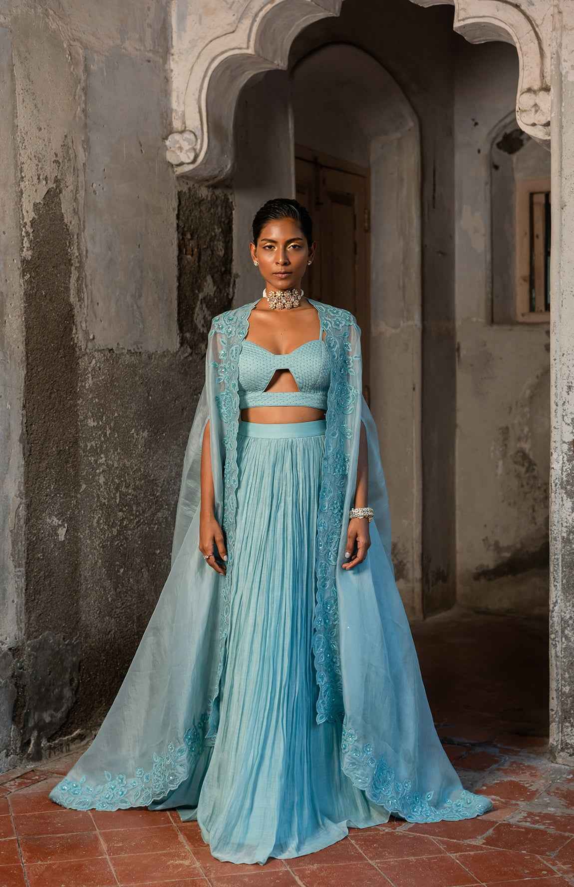 A Pwder Blue Lehenga With Maching Blouse And Cape
