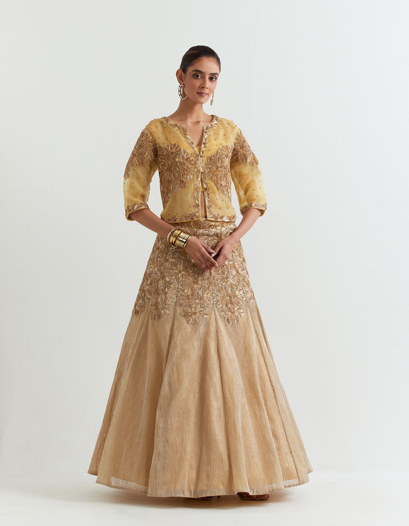 Organza silk gota embroidered jacket paired with corset inner and mesh textured and embroidered panelled skirt