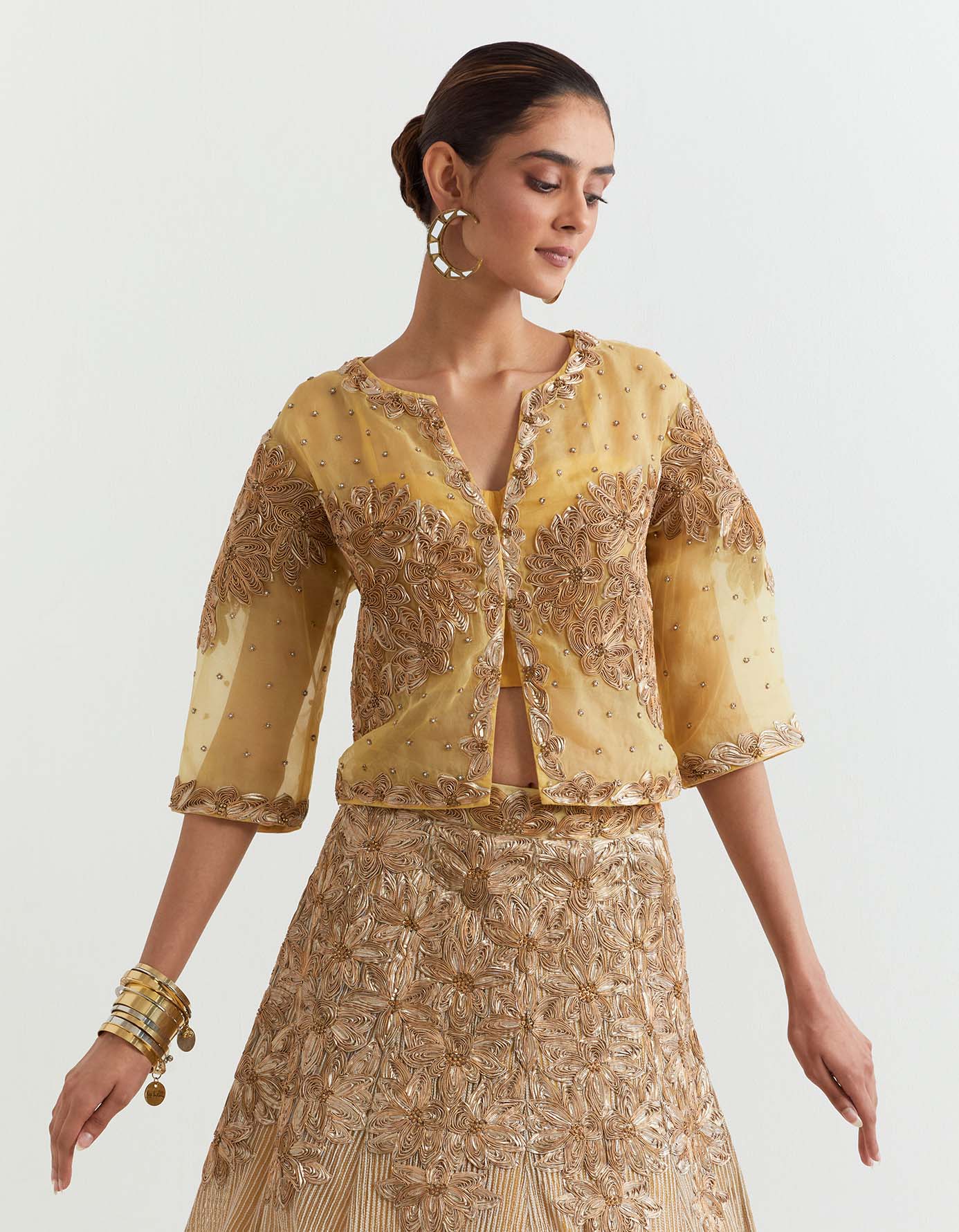 Organza silk gota embroidered jacket paired with corset inner and mesh textured and embroidered panelled skirt