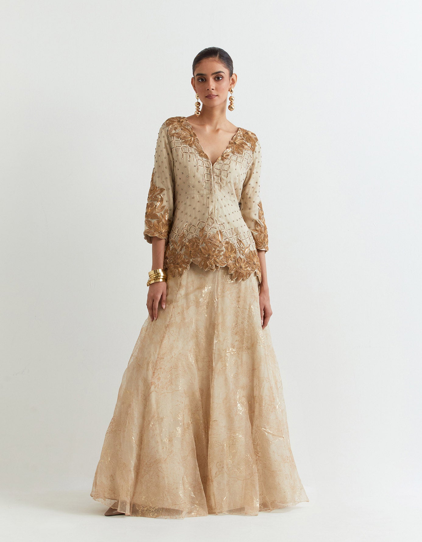 Organza embroidered peplum jacket paired with all over self and foil printed silk organza skirt
