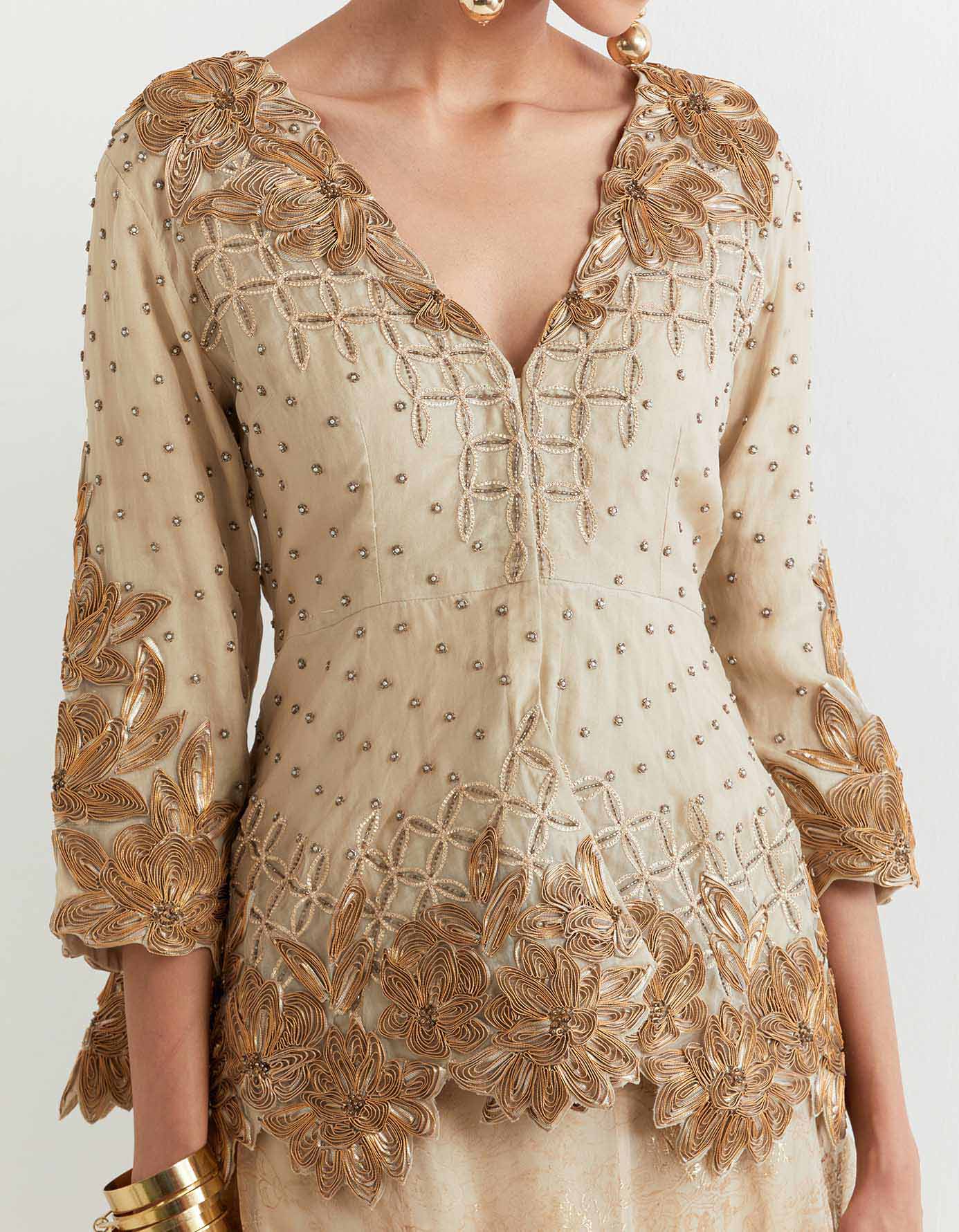 Organza embroidered peplum jacket paired with all over self and foil printed silk organza skirt