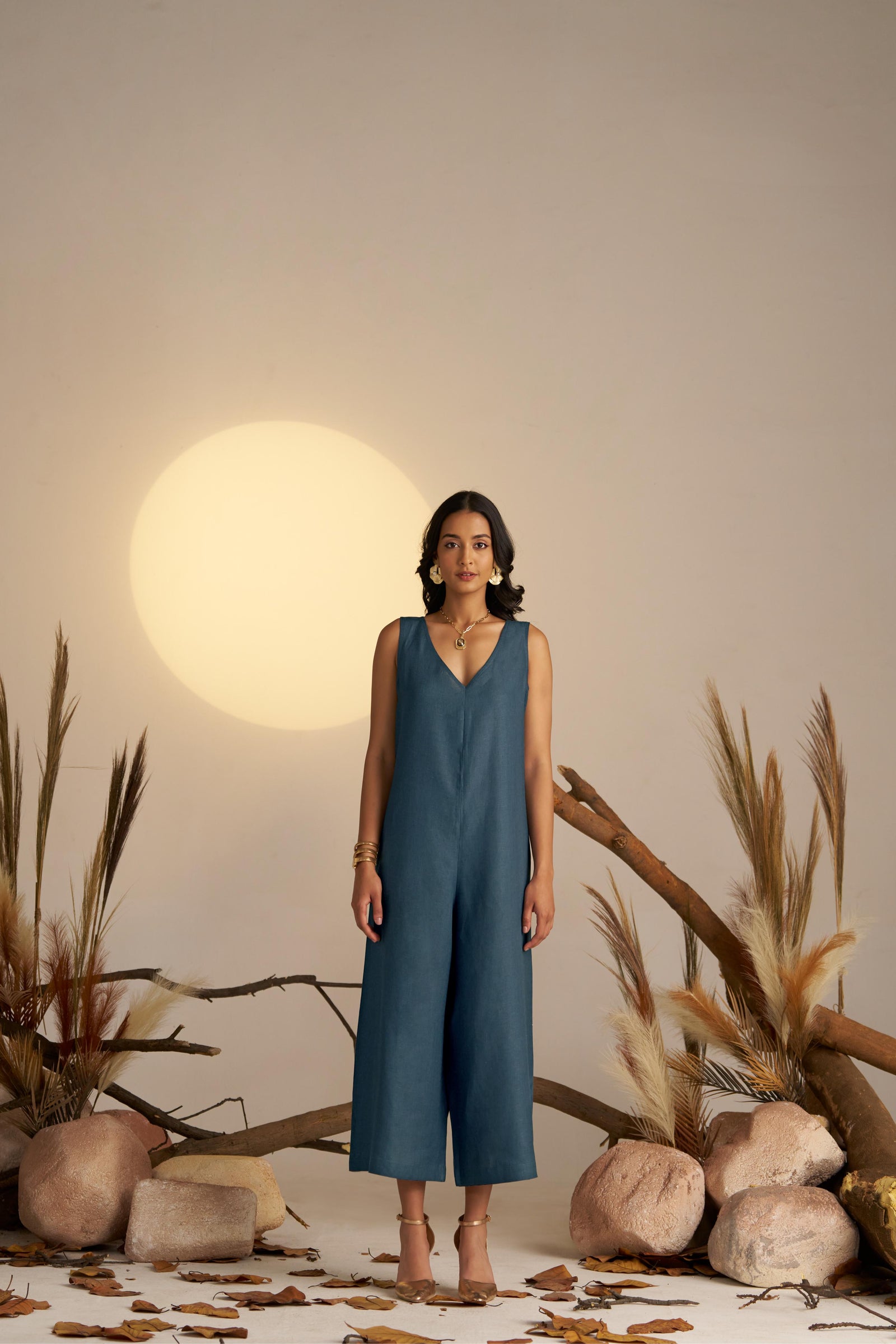 A Sleek Sleeveless Jumpsuit In A Deep Midnight Blue Hue, Designed With A Flattering Silhouette And Minimalist Detailing