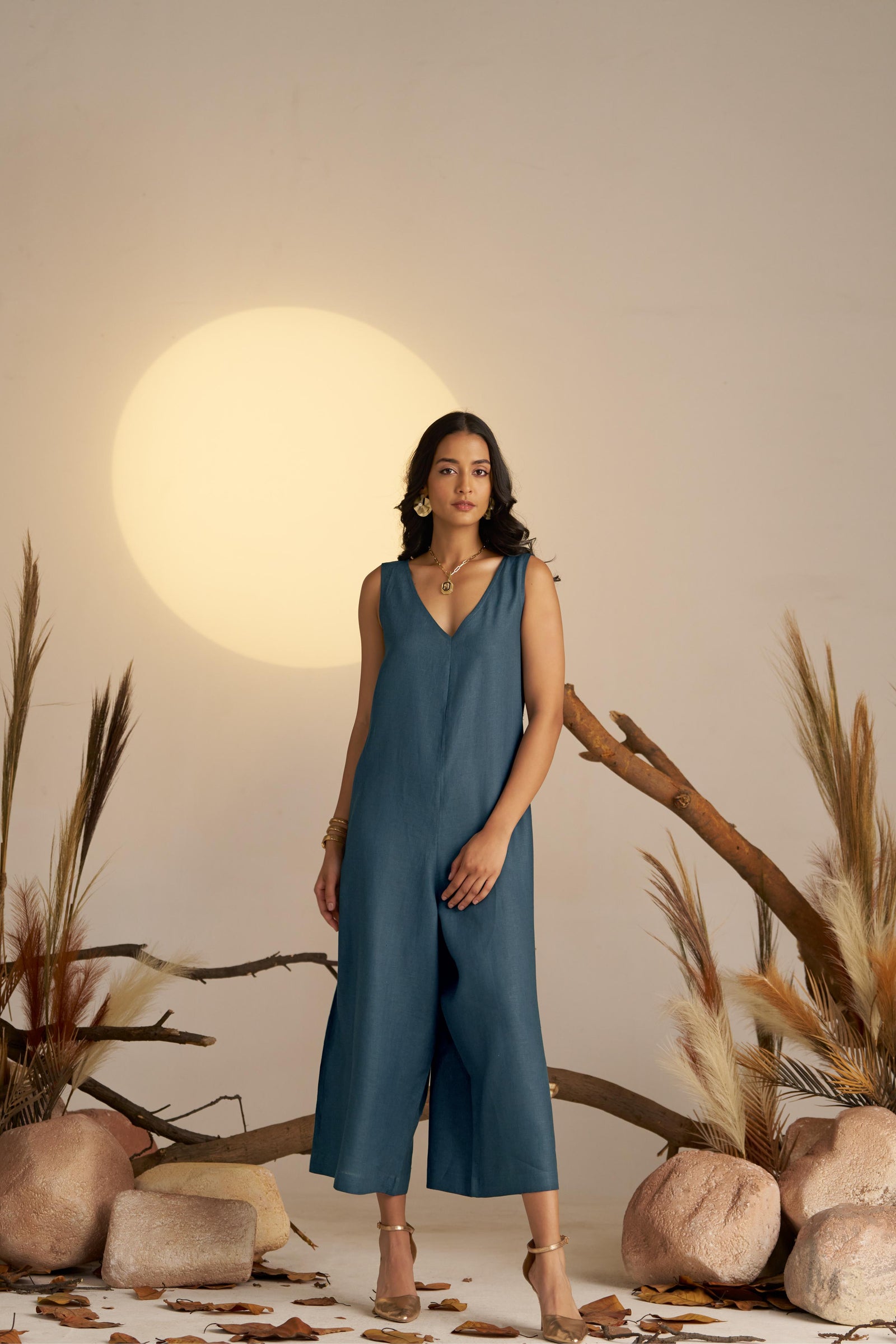 A Sleek Sleeveless Jumpsuit In A Deep Midnight Blue Hue, Designed With A Flattering Silhouette And Minimalist Detailing
