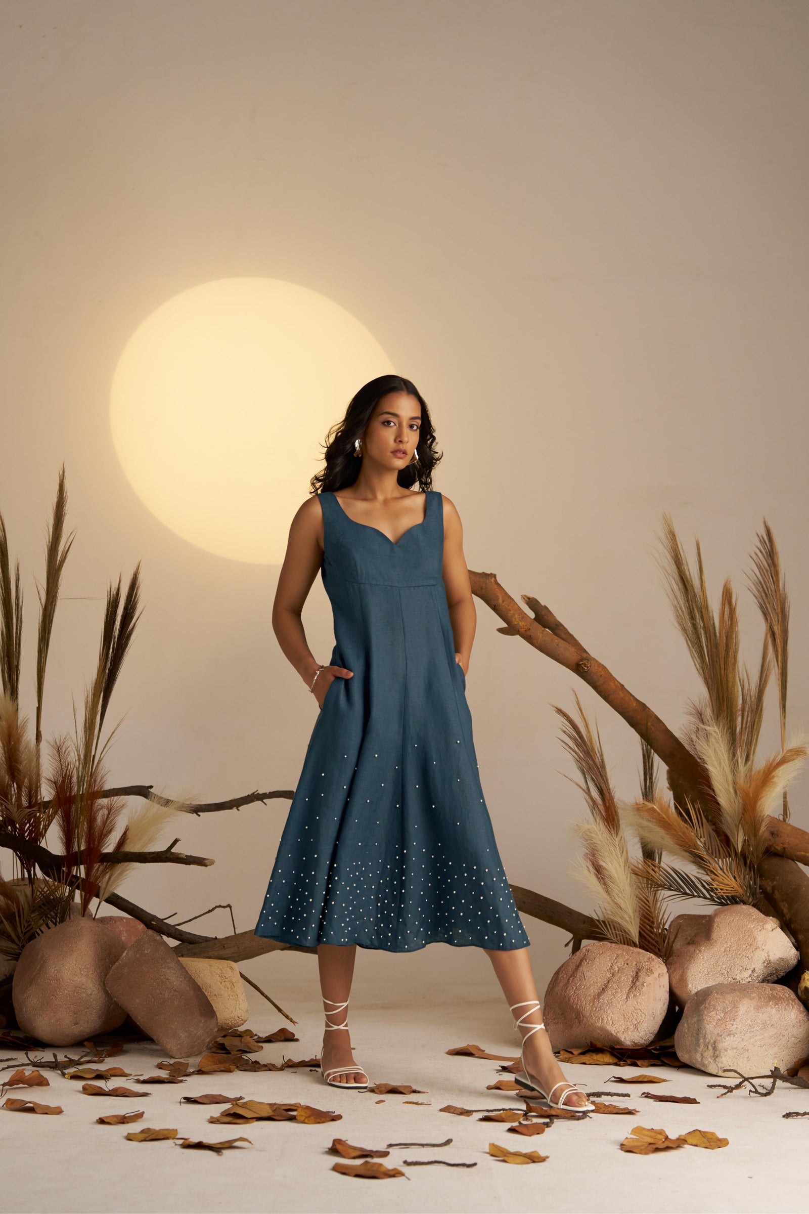 A Stunning Sleeveless Dress In Rich Midnight Blue, Featuring Delicate Pearl Embellishments Along The Hem For A Touch Of Elegance