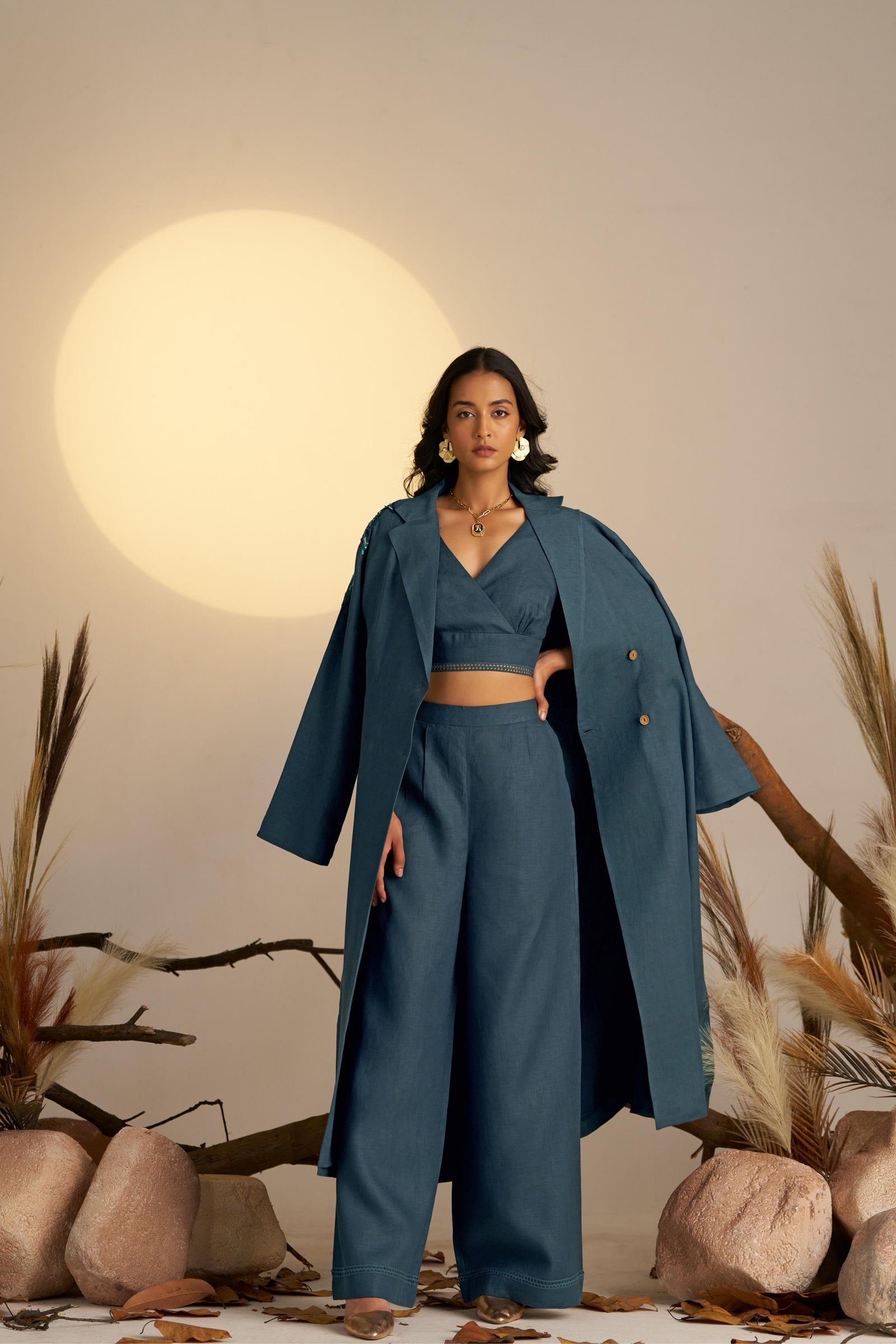 A Chic Midnight Blue Trench Coat, Featuring Classic Tailoring With A Touch Of Glam—sequined Embroidery On One Shoulder Adds A Unique, Eye-catching Detail