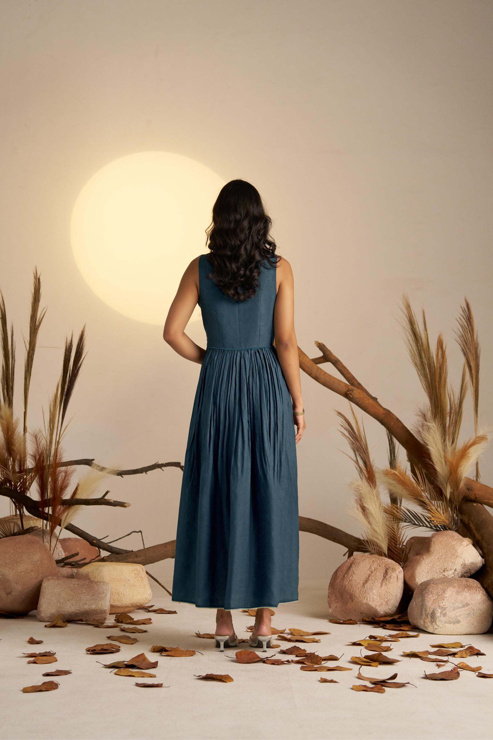 A Stunning Midnight Blue Pleated Dress, Cinched At The Waist To Create A Flattering, Feminine Silhouette