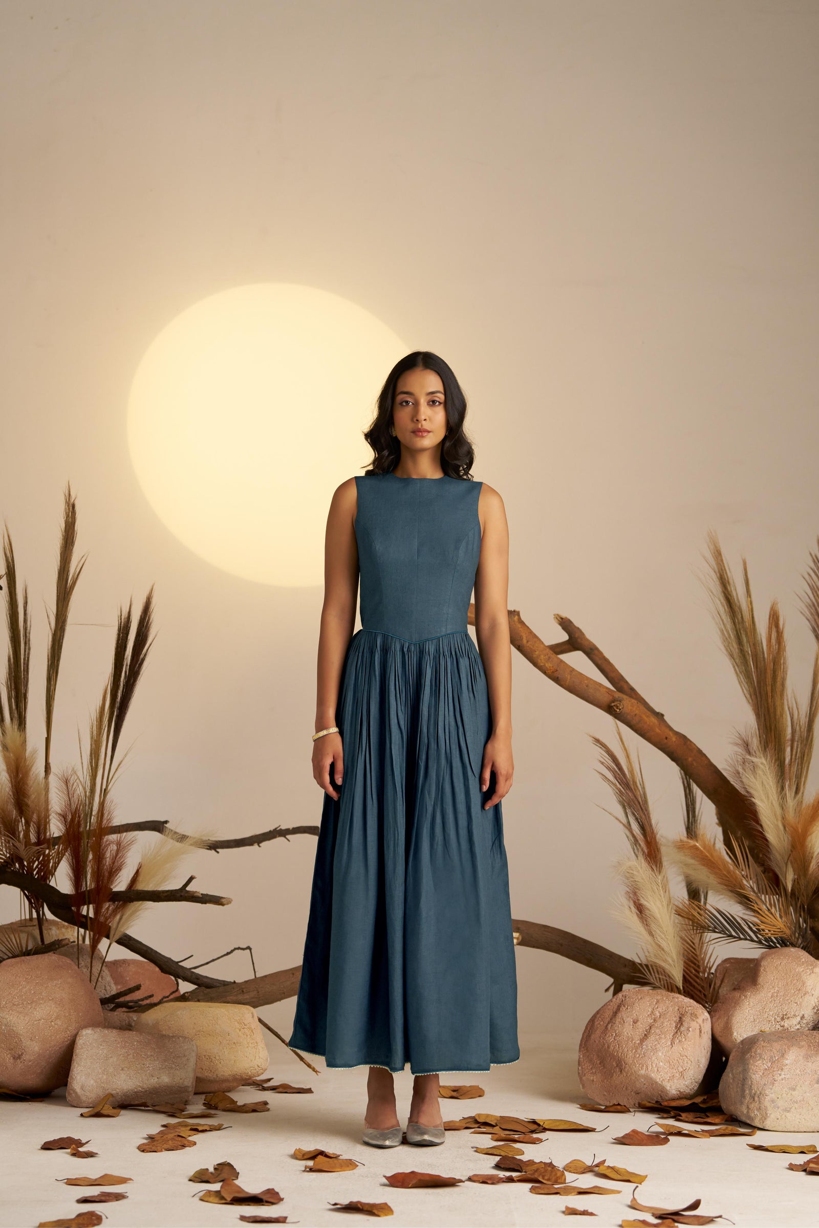 A Stunning Midnight Blue Pleated Dress, Cinched At The Waist To Create A Flattering, Feminine Silhouette