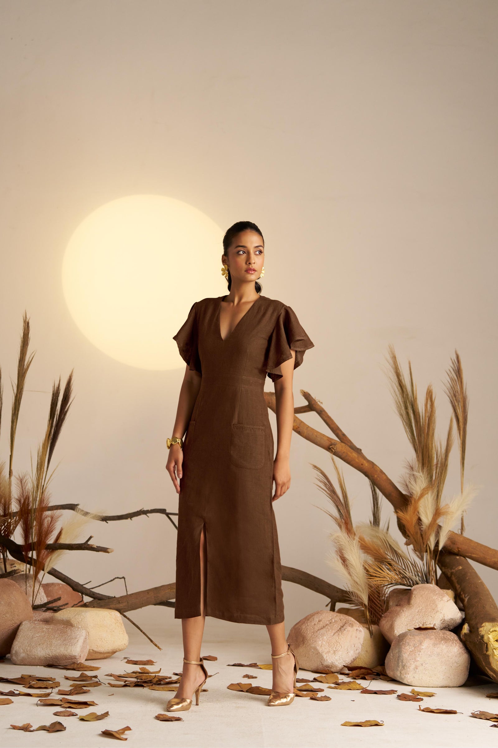 A Refined Straight-fitted Dress In A Warm Sepia Tone, Featuring Graceful Waterfall Sleeves And Intricate Self Lace Detailing