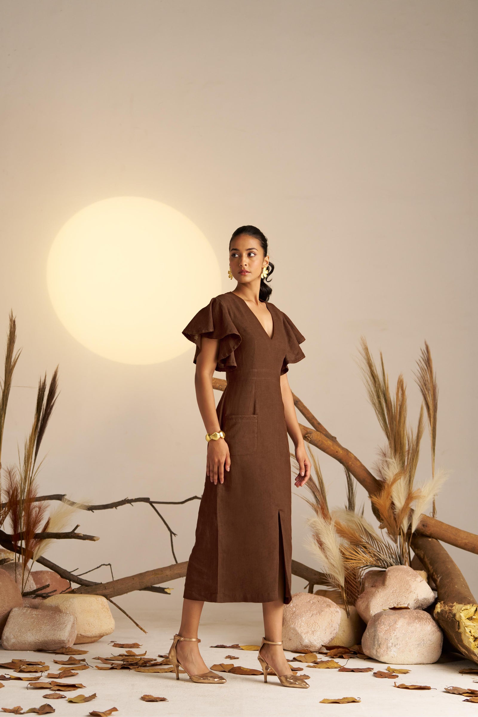 A Refined Straight-fitted Dress In A Warm Sepia Tone, Featuring Graceful Waterfall Sleeves And Intricate Self Lace Detailing