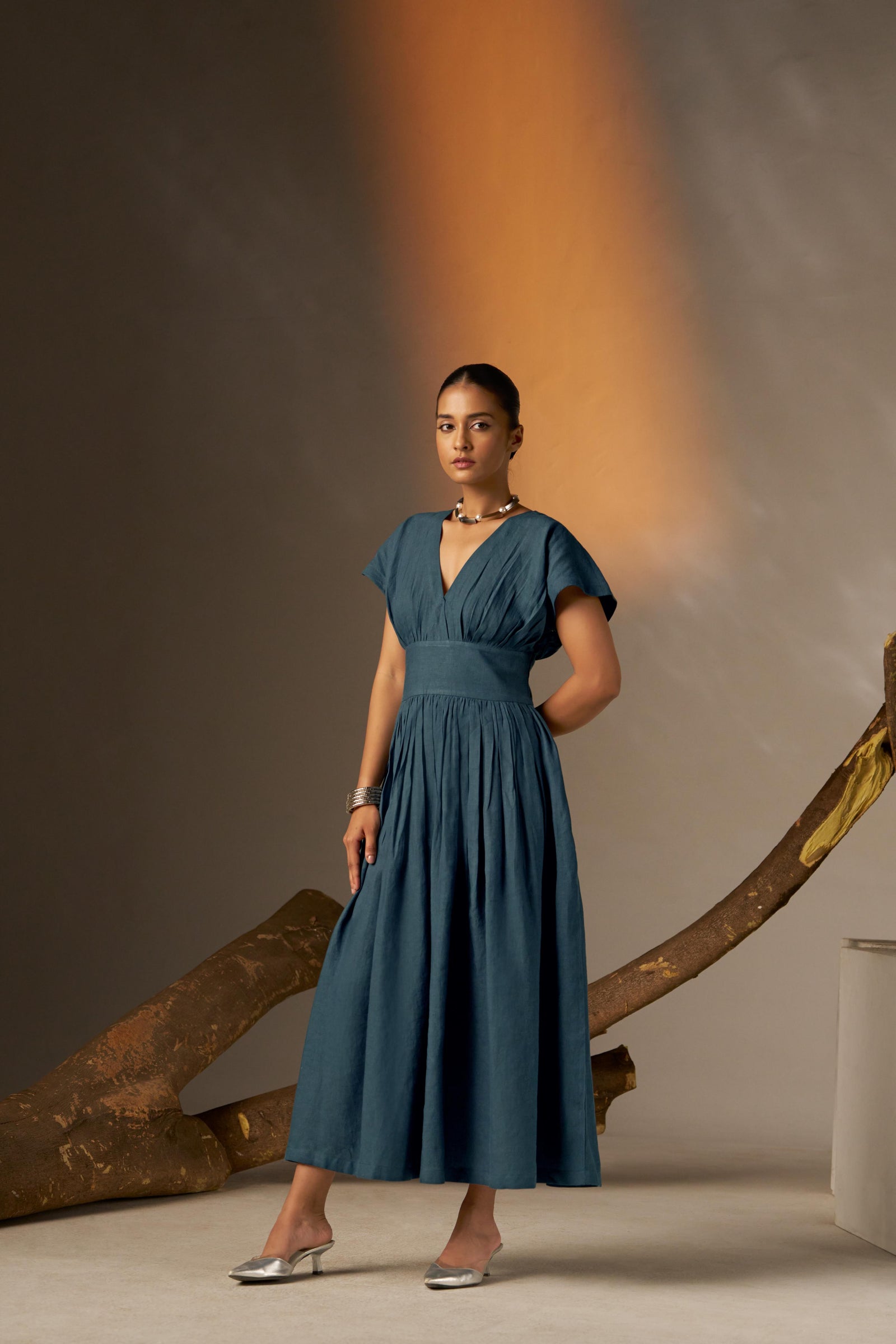 An Elegant Dress In Rich Midnight Blue, Featuring A Defined Waistline And Soft Cap Sleeves For A Feminine, Tailored Look