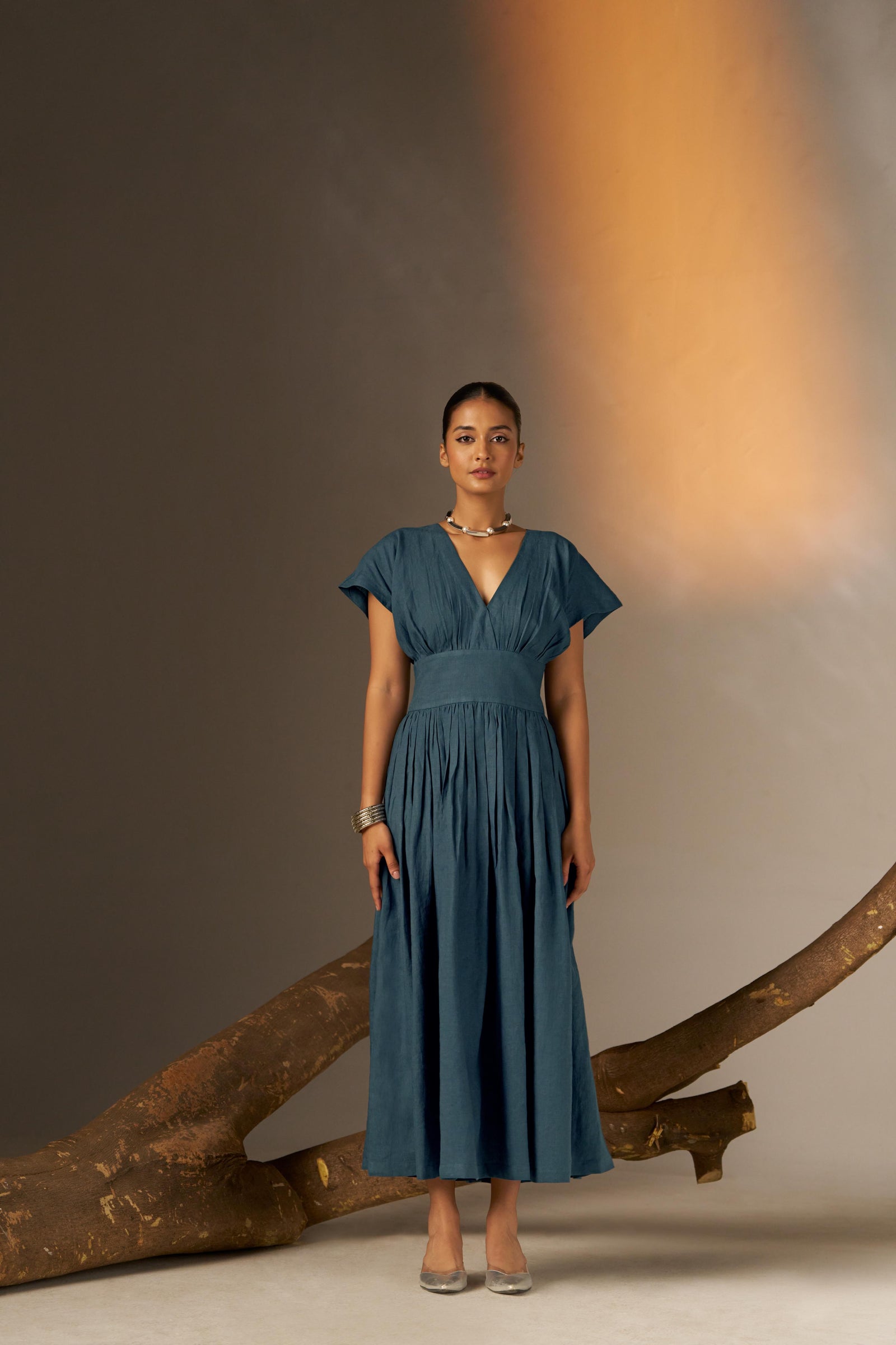 An Elegant Dress In Rich Midnight Blue, Featuring A Defined Waistline And Soft Cap Sleeves For A Feminine, Tailored Look