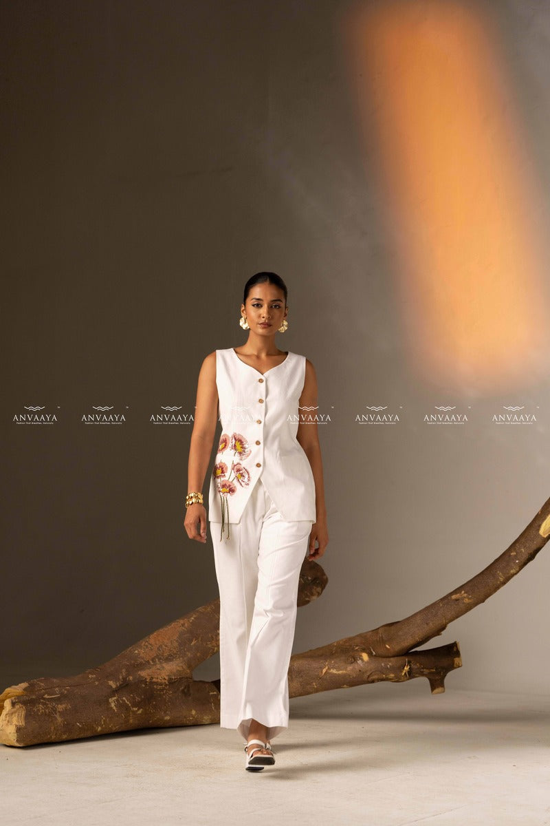 An Elegant White Sleeveless Long Vest Adorned With Delicate Floral Embellishments